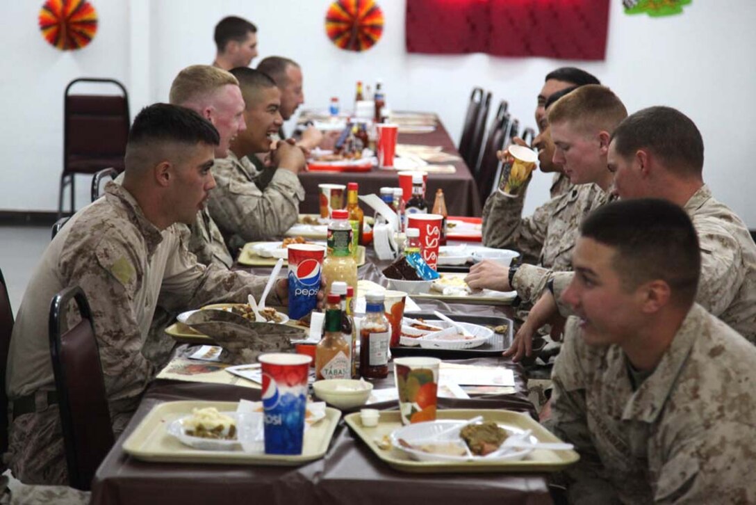Marines assigned to the 15th Marine Expeditionary Unit take a break from training to serve other Marines and sailors a Thanksgiving holiday meal at Camp Buehring, Kuwait, during Exercise Eager Mace 13, Nov. 22. The U.S. Navy and Marine Corps are participating in the bilateral training exercise with the Kuwait Armed Forces to expand levels of cooperation, enhance mutual maritime capabilities and promote long-term regional stability and interoperability between U.S. forces and regional partners. The 15th MEU is deployed as part of the Peleliu Amphibious Ready Group as a U.S. Central Command theater reserve force, providing support for maritime security operations and theater security cooperation efforts in the U.S. 5th Fleet area of responsibility. (U.S. Marine Corps photo by Cpl. Timothy R. Childers/Released)
