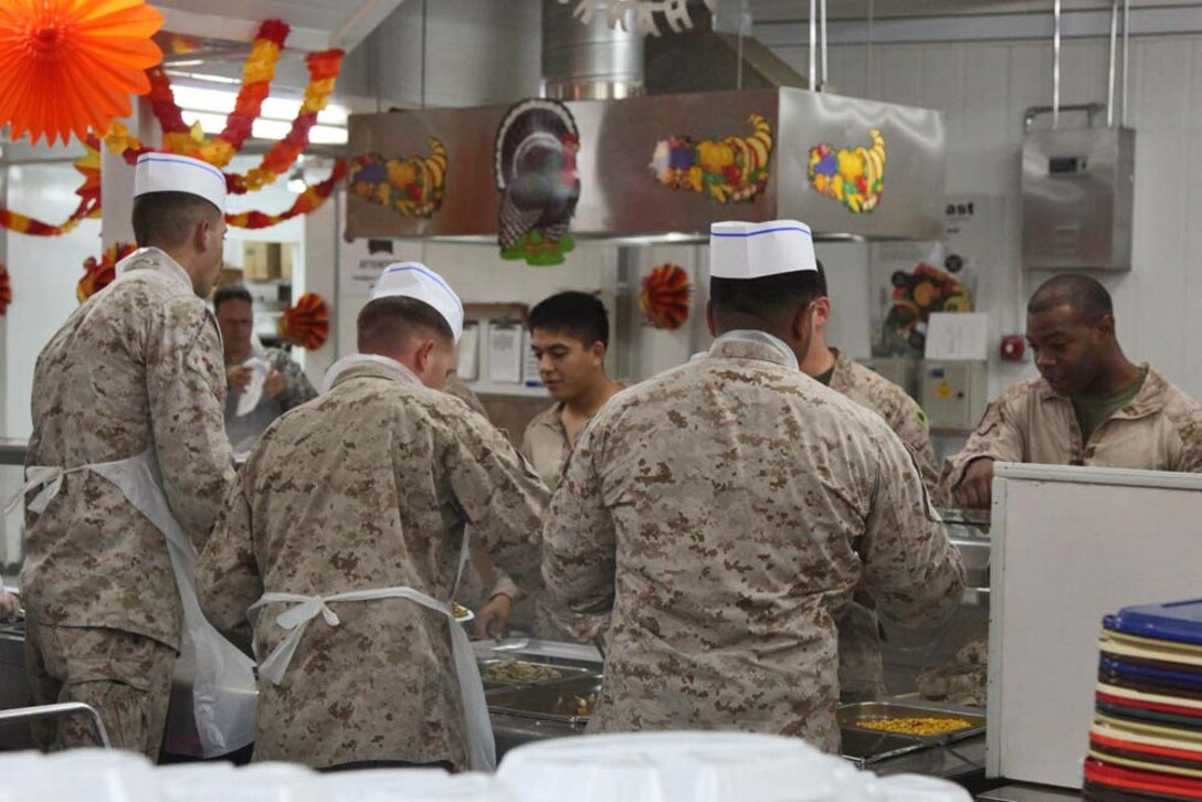 Marines assigned to the 15th Marine Expeditionary Unit take a break from training to enjoy a Thanksgiving holiday meal at Camp Buehring, Kuwait, during Exercise Eager Mace 13, Nov. 22. The U.S. Navy and Marine Corps are participating in the bilateral training exercise with the Kuwait Armed Forces to expand levels of cooperation, enhance mutual maritime capabilities and promote long-term regional stability and interoperability between U.S. forces and regional partners. The 15th MEU is deployed as part of the Peleliu Amphibious Ready Group as a U.S. Central Command theater reserve force, providing support for maritime security operations and theater security cooperation efforts in the U.S. 5th Fleet area of responsibility. (U.S. Marine Corps photo by Cpl. Timothy R. Childers/Released)
