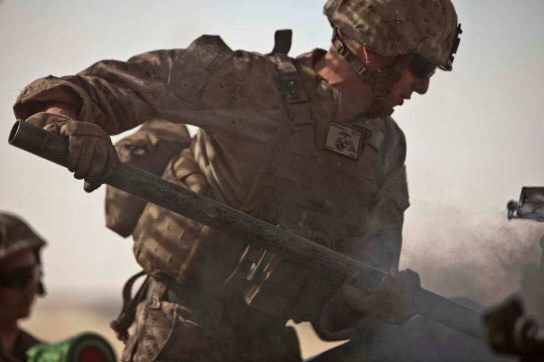 A U.S. Marine with Bravo Battery, 1st Battalion, 11th Marine Regiment, 15th Marine Expeditionary Unit, swabs the breach of an M777A2 Lightweight Howitzer Lightweight Howitzer after firing as part of Eager Mace 13, aboard Forward Operating Base Sword, Kuwait November 14, 2012. The purpose of the exercise is to expand levels of cooperation, maritime capabilities, as well as promote long-term regional stability and interoperability between U.S. forces and regional partners. (U.S. Marine Corps photo by Cpl. Bobby J. Gonzalez/Not Reviewed)