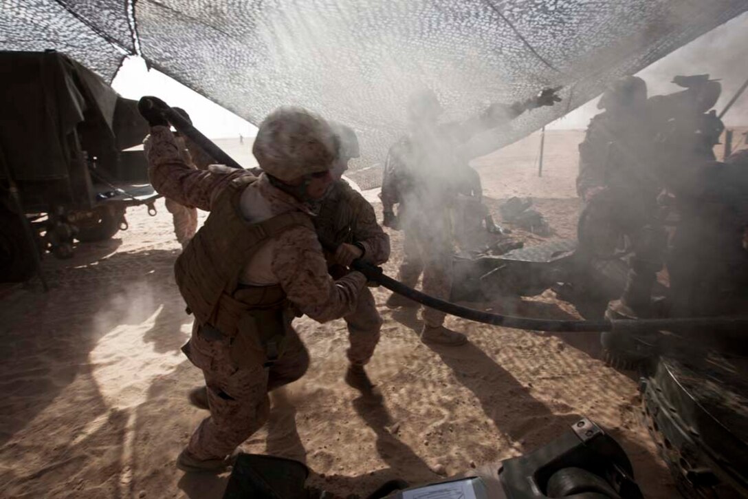 U.S. Marines with Bravo Battery, 1st Battalion, 11th Marine Regiment, 15th Marine Expeditionary Unit, load ammunition into a M777A2 Lightweight Howitzer as part of Eager Mace 13, aboard Forward Operating Base Sword, Kuwait November 14, 2012. The purpose of the exercise is to expand levels of cooperation, maritime capabilities, as well as promote long-term regional stability and interoperability between U.S. forces and regional partners. (U.S. Marine Corps photo by Cpl. Bobby J. Gonzalez/Not Reviewed)