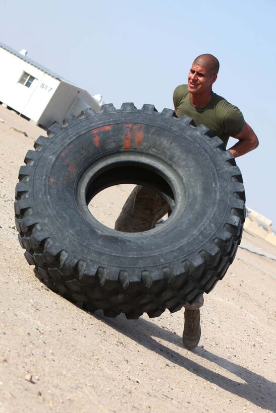 Lance Cpl. Victor W. Hillmann, machine gunner, Combined Anti-armor Team 1, Weapons Company, Battalion Landing Team 3/5, 15th Marine Expeditionary Unit, works out with a tire at Camp Buehring, in preparation for Exercise Eager Mace 13, Nov. 9. The U.S. Navy and Marine Corps are participating in the bilateral training exercise with the Kuwait Armed Forces Nov. 11-21. The U.S. Navy and Marine Corps are participating in the bilateral training exercise with the Kuwait Armed Forces to expand levels of cooperation, enhance mutual maritime capabilities and promote long-term regional stability and interoperability between U.S. forces and regional partners. The 15th MEU is deployed as part of the Peleliu Amphibious Ready Group as a U.S. Central Command theater reserve force, providing support for maritime security operations and theater security cooperation efforts in the U.S. 5th Fleet area of responsibility. Hillmann, 20, is from Sparta, Mich. (U.S. Marine Corps photo by Cpl. Timothy Childers/Released)