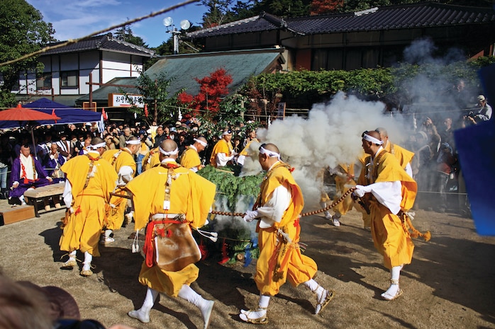 Buddhist monks perform part of a ritual for the
Hiwatari Shinji, or firewalking ceremony, which
took place inside the Daisho-in, a historical
Japanese temple, on Miyajima Nov. 15, 2012. After the haze clears, the monks then pass out sticks of wood with prayers written by those attending inscribed on them. Handfuls of prayer sticks are thrown into the blaze, releasing the wishes of the pilgrims and granting good luck.