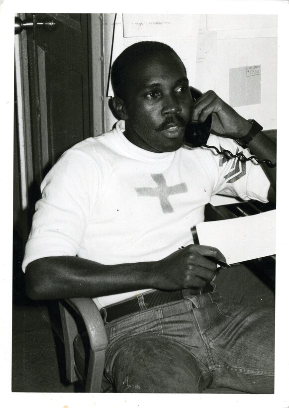 Petty Officer 1st Class Moise Willis answers the phone in his office aboard the USS Enterprise at Pearl Harbor, Hawaii, 1984. Willis was the aviation medicine technician aboard the Enterprise from 1982 to 1987.