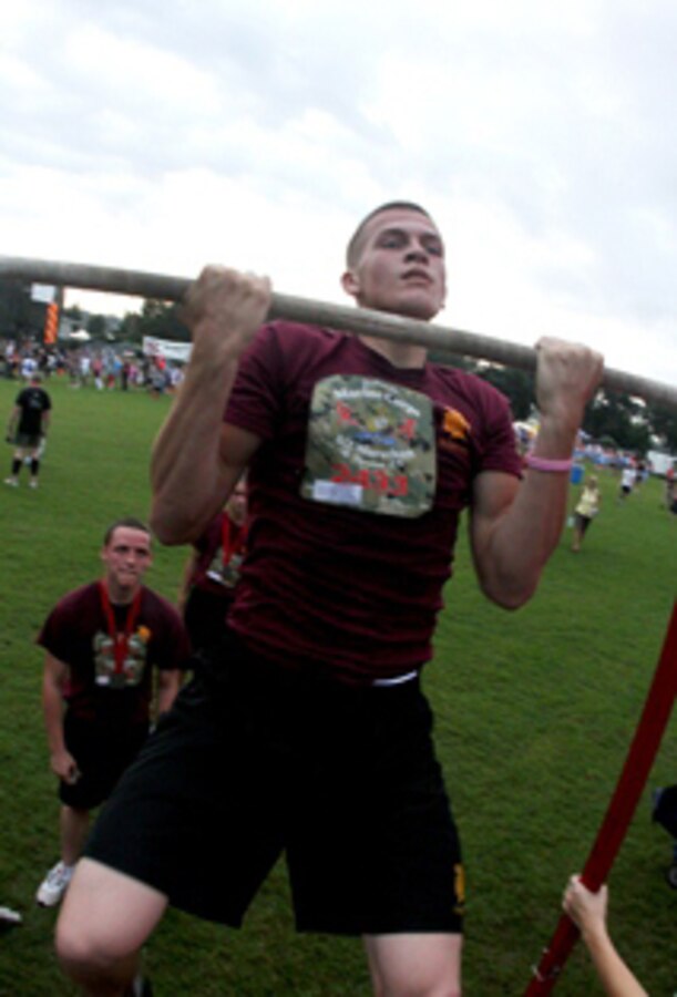 A participant of the Marine Corps Half Marathon performs pullups after completing the 5K portion of the event, held at Met Park, Jacksonville, FL, Oct.6th.