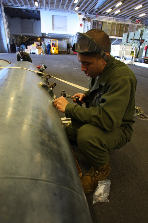 USS IWO JIMA, Mediterranean Sea (Nov. 27, 2012) - Sgt. Robert Chavez, a Los Angeles, native with Marine Medium Tiltrotor Squadron 261 (Reinforced), 24th Marine Expeditionary Unit, drills a new bolt hole on an AV-8B Harrier fuel tank aboard USS Iwo Jima, Nov. 27, 2012. The 24th Marine Expeditionary Unit is deployed with the Iwo Jima Amphibious Ready Group in the 6th Fleet area of responsibility serving as an expeditionary crisis response force capable of a variety of missions, from full-scale combat to evacuations and humanitarian assistance. Since deploying in March, they have supported a variety of missions in the U.S. Central, Africa and European Commands, assisted the Navy in safeguarding sea lanes, and conducted various bilateral and unilateral training events in several countries in the Middle East and Africa. (U.S. Marine Corps photo by Lance Cpl. Tucker S. Wolf/Released)