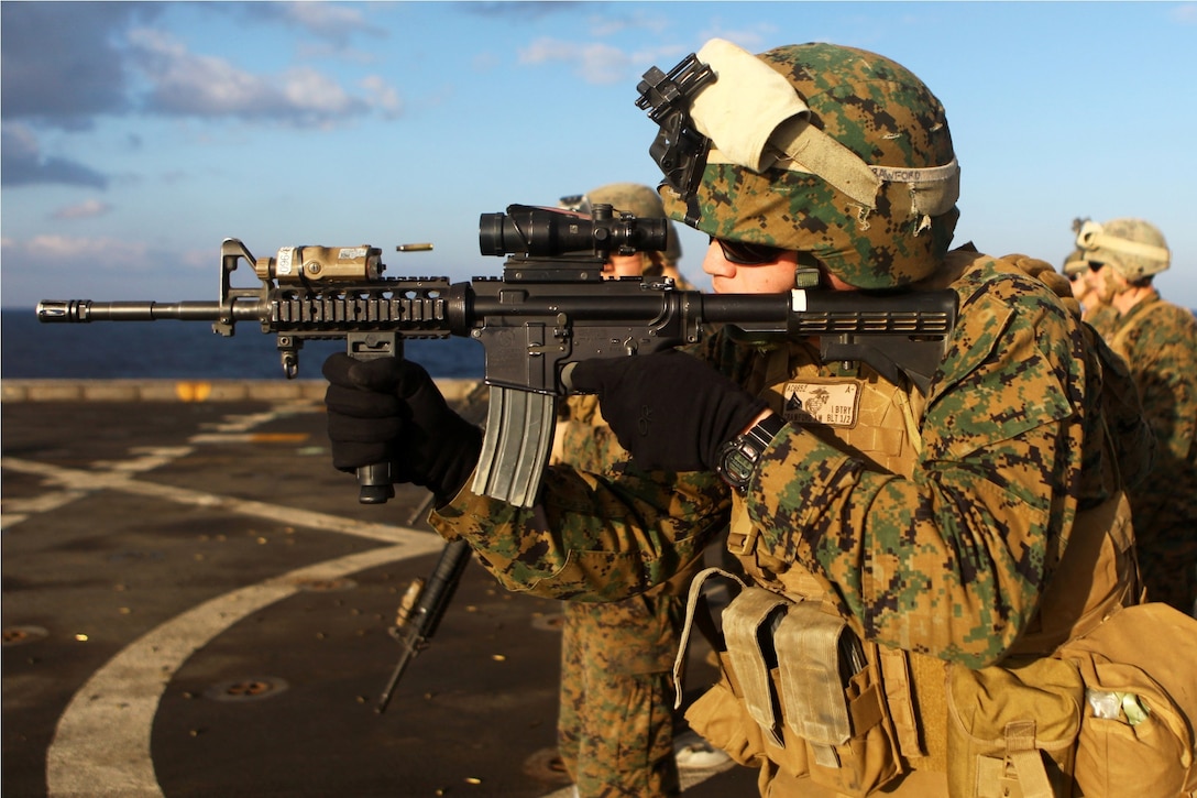 USS NEW YORK, Mediterranean Sea (Nov. 26, 2012) – Cpl. Andrew Crawford, a native of Clermont, Fla., and small arms technician with India Battery, the artillery unit attached to Battalion Landing Team 1st Battalion, 2nd Marine Regiment, 24th Marine Expeditionary Unit, fires an M-4 Carbine during combat marksmanship training on the flight deck of the USS New York , Nov. 26, 2012. The 24th Marine Expeditionary Unit is deployed with the Iwo Jima Amphibious Ready Group in the 6th Fleet area of responsibility, serving as an expeditionary crisis response force capable of a variety of missions from full-scale combat to evacuations and humanitarian assistance. (Marine Corps photo by Cpl. Michael Petersheim)