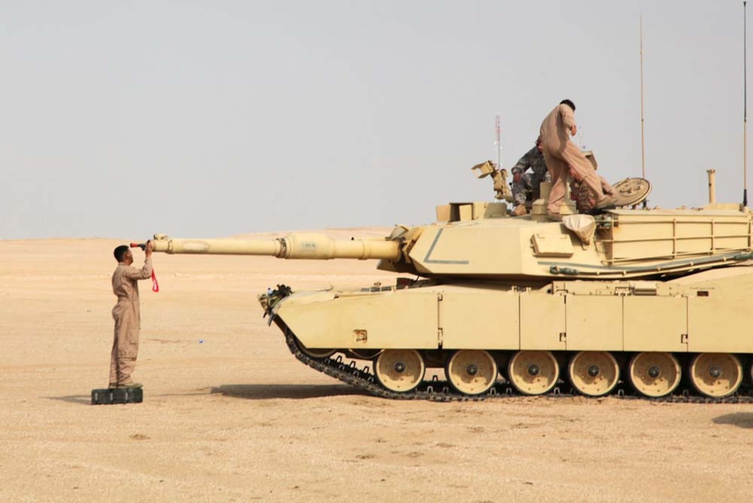 Lance Corporal Ruben Reyes, tank crewman, Tanks Platoon, India Company, Battalion Landing Team 3/5, 15th Marine Expeditionary Unit, inserts a bore sight into the barrel of an M1A2 Abrams tank at a live-fire range near Camp Buehring, during Exercise Eager Mace 13, Nov. 13. The U.S. Navy and Marine Corps are participating in the bilateral training exercise with the Kuwait Armed Forces to expand levels of cooperation, enhance mutual maritime capabilities and promote long-term regional stability and interoperability between U.S. forces and regional partners. The 15th MEU is deployed as part of the Peleliu Amphibious Ready Group as a U.S. Central Command theater reserve force, providing support for maritime security operations and theater security cooperation efforts in the U.S. 5th Fleet area of responsibility. (U.S. Marine Corps photo by Cpl. Timothy Childers/Released)