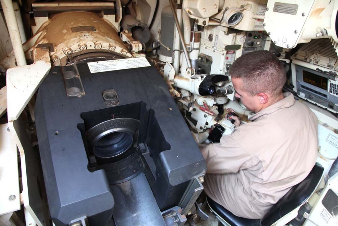 Corporal Joseph T. Cheeseman, tank crewman, Tanks Platoon, India Company, Battalion Landing Team 3/5, 15th Marine Expeditionary Unit, adjust the sights in an M1A2 Abrams tank at a live-fire range near Camp Buehring, during Exercise Eager Mace 13, Nov. 13. The U.S. Navy and Marine Corps are participating in the bilateral training exercise with the Kuwait Armed Forces to expand levels of cooperation, enhance mutual maritime capabilities and promote long-term regional stability and interoperability between U.S. forces and regional partners. The 15th MEU is deployed as part of the Peleliu Amphibious Ready Group as a U.S. Central Command theater reserve force, providing support for maritime security operations and theater security cooperation efforts in the U.S. 5th Fleet area of responsibility. (U.S. Marine Corps photo by Cpl. Timothy Childers/Released)