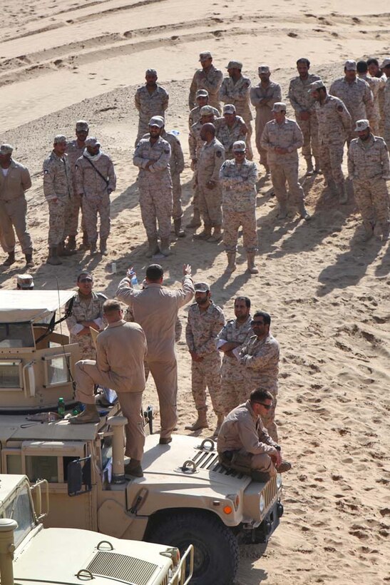 First Lt. Tyler W. Garrett, platoon commander, Tanks Platoon, India Company Battalion Landing Team 3/5, 15th Marine Expeditionary Unit, teaches Kuwaiti tank crewmen how to assault an objective at a live-fire range near Camp Buehring, during Exercise Eager Mace 13, Nov. 14. Marines alongside the U.S. Army were instructing members of the Kuwait Armed Forces how to assault an enemy force. The U.S. Navy and Marine Corps are participating in the bilateral training exercise with the Kuwait Armed Forces to expand levels of cooperation, enhance mutual maritime capabilities and promote long-term regional stability and interoperability between U.S. forces and regional partners. The 15th MEU is deployed as part of the Peleliu Amphibious Ready Group as a U.S. Central Command theater reserve force, providing support for maritime security operations and theater security cooperation efforts in the U.S. 5th Fleet area of responsibility. Garrett, 24, is from Bangor, Maine. (U.S. Marine Corps photo by Cpl. Timothy Childers/Released)