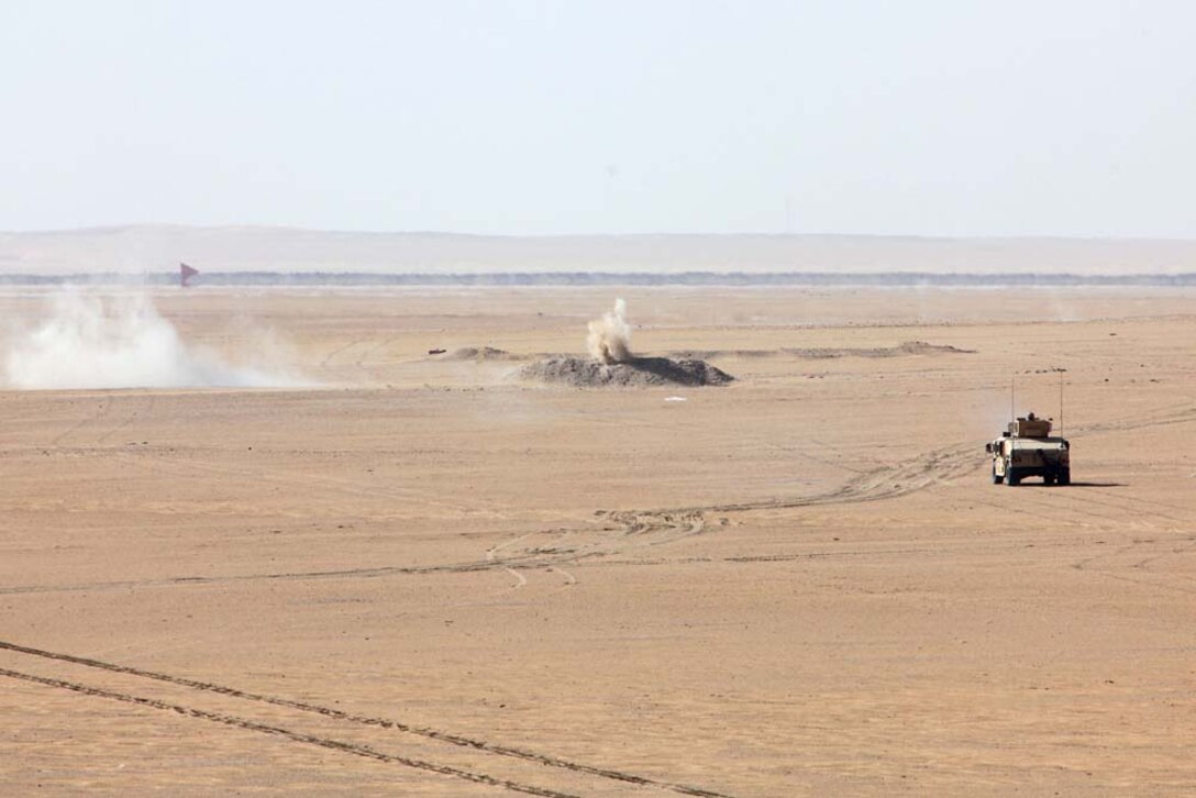 A humvee from Combined Anti-Armor Team 2, Weapons Company, Battalion Landing Team 3/5, 15th Marine Expeditionary Unit, assaults an objective alongside a U.S. Army tank team at a live-fire range near Camp Buehring, during Exercise Eager Mace 13, Nov. 14. Marines and soldiers were instructing members of the Kuwait Armed Forces how to assault an enemy force. The U.S. Navy and Marine Corps are participating in the bilateral training exercise with the Kuwait Armed Forces to expand levels of cooperation, enhance mutual maritime capabilities and promote long-term regional stability and interoperability between U.S. forces and regional partners. The 15th MEU is deployed as part of the Peleliu Amphibious Ready Group as a U.S. Central Command theater reserve force, providing support for maritime security operations and theater security cooperation efforts in the U.S. 5th Fleet area of responsibility. (U.S. Marine Corps photo by Cpl. Timothy Childers/Released)