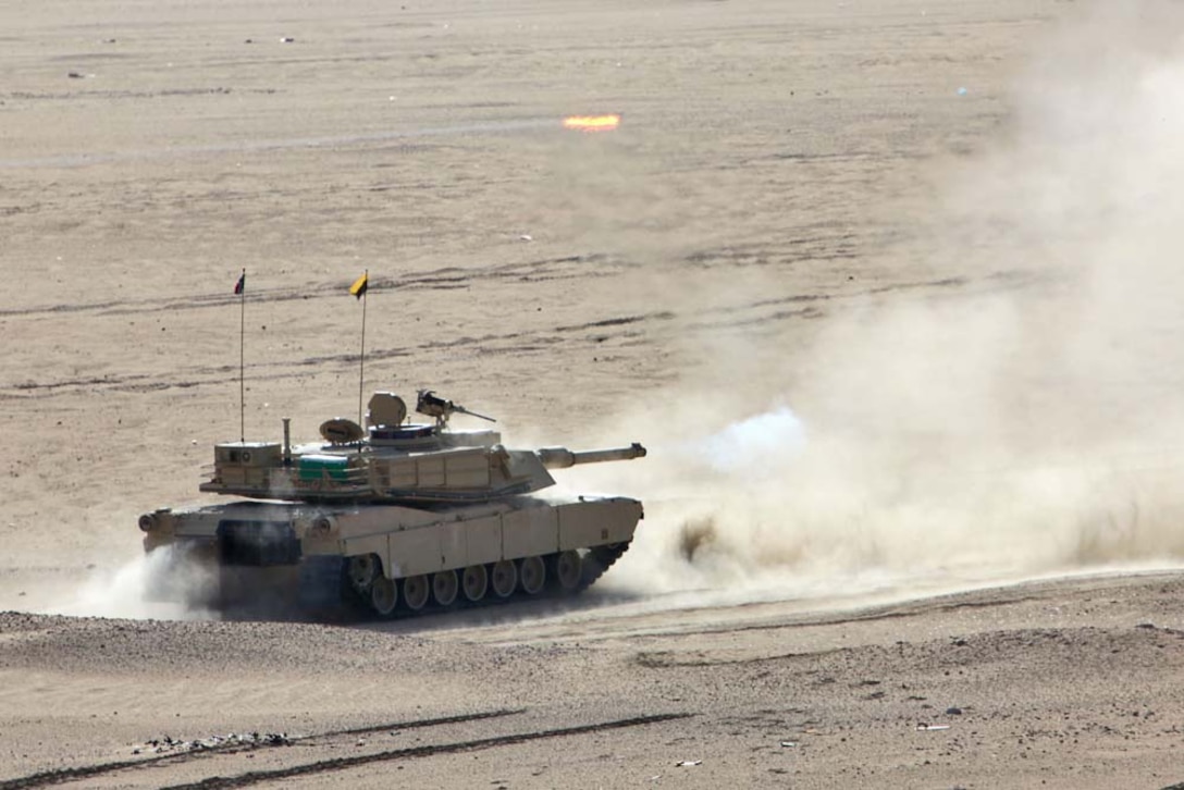 An M1A2 Abrams tank fires at a target at a live-fire range near Camp Buehring, during Exercise Eager Mace 13, Nov. 14. Marines from Tanks Platoon, India Company Battalion Landing Team 3/5, 15th Marine Expeditionary Unit, alongside the U.S. Army were teaching members of the Kuwait Armed Forces how to assault an enemy force. The U.S. Navy and Marine Corps are participating in the bilateral training exercise with the Kuwait Armed Forces to expand levels of cooperation, enhance mutual maritime capabilities and promote long-term regional stability and interoperability between U.S. forces and regional partners. The 15th MEU is deployed as part of the Peleliu Amphibious Ready Group as a U.S. Central Command theater reserve force, providing support for maritime security operations and theater security cooperation efforts in the U.S. 5th Fleet area of responsibility. (U.S. Marine Corps photo by Cpl. Timothy Childers/Released)