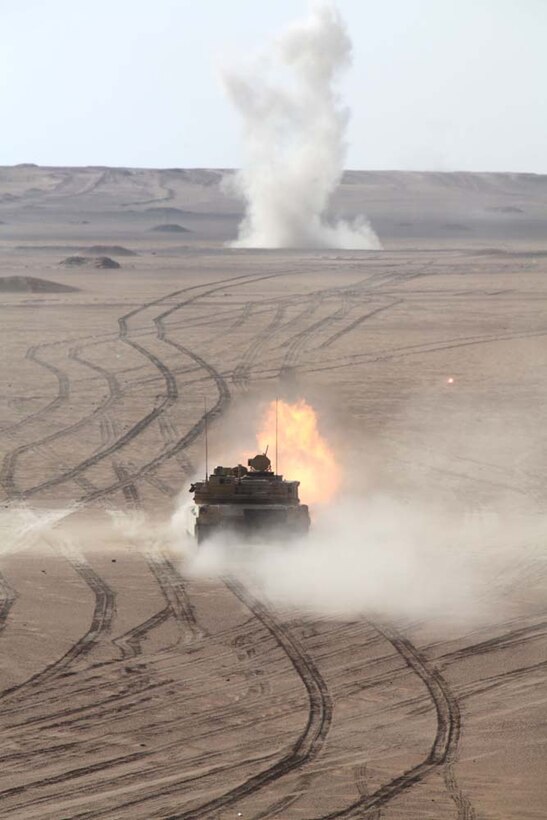 An M1A2 Abrams tank fires at a target at a live-fire range near Camp Buehring, during Exercise Eager Mace 13, Nov. 14. Marines from Tanks Platoon, India Company Battalion Landing Team 3/5, 15th Marine Expeditionary Unit, alongside the U.S. Army were teaching members of the Kuwait Armed Forces how to assault an enemy force. The U.S. Navy and Marine Corps are participating in the bilateral training exercise with the Kuwait Armed Forces to expand levels of cooperation, enhance mutual maritime capabilities and promote long-term regional stability and interoperability between U.S. forces and regional partners. The 15th MEU is deployed as part of the Peleliu Amphibious Ready Group as a U.S. Central Command theater reserve force, providing support for maritime security operations and theater security cooperation efforts in the U.S. 5th Fleet area of responsibility. (U.S. Marine Corps photo by Cpl. Timothy Childers/Released)