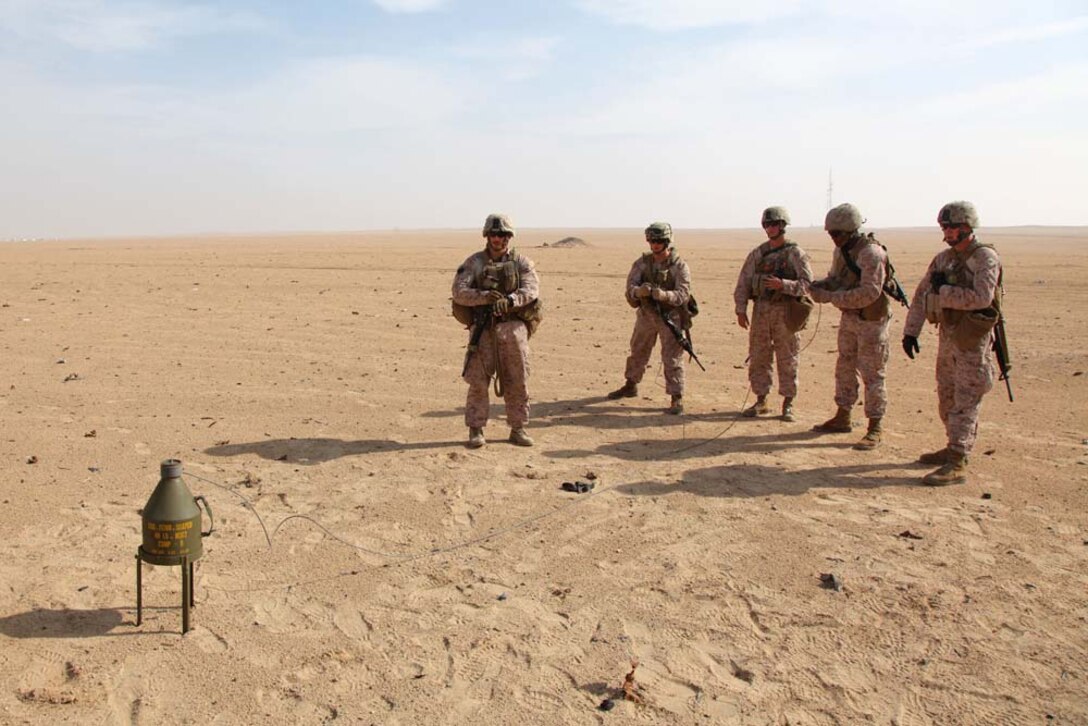 Marines assigned to Engineer Detachment, Combat Logistics Battalion 15, 15th Marine Expeditionary Unit, light a fuse for a shape charge for a controlled detonation at a live-fire range near Camp Buehring, Kuwait, during a routine training exercise, Nov. 25. With the use of shape and cratering charges and composition C-4, the combat engineers were able to use the high explosives to demonstrate practical applications they could use in a combat environment. The 15th MEU is deployed as part of the Peleliu Amphibious Ready Group as a U.S. Central Command theater reserve force, providing support for maritime security operations and theater security cooperation efforts in the U.S. 5th Fleet area of responsibility. (U.S. Marine Corps photo by Cpl. Timothy R. Childers)