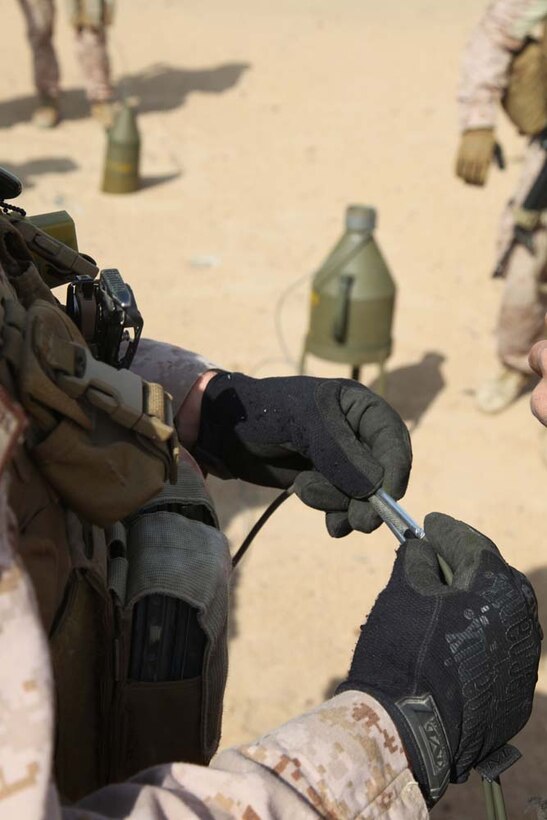 A Marine assigned to Engineer Detachment, Combat Logistics Battalion 15, 15th Marine Expeditionary Unit, prepares a fuse to use for a controlled detonation at a live-fire range near Camp Buehring, Kuwait, during a routine training exercise, Nov. 25. With the use of shape and cratering charges and composition C-4, the combat engineers were able to use the high explosives to demonstrate practical applications they could use in a combat environment. The 15th MEU is deployed as part of the Peleliu Amphibious Ready Group as a U.S. Central Command theater reserve force, providing support for maritime security operations and theater security cooperation efforts in the U.S. 5th Fleet area of responsibility. (U.S. Marine Corps photo by Cpl. Timothy R. Childers)
