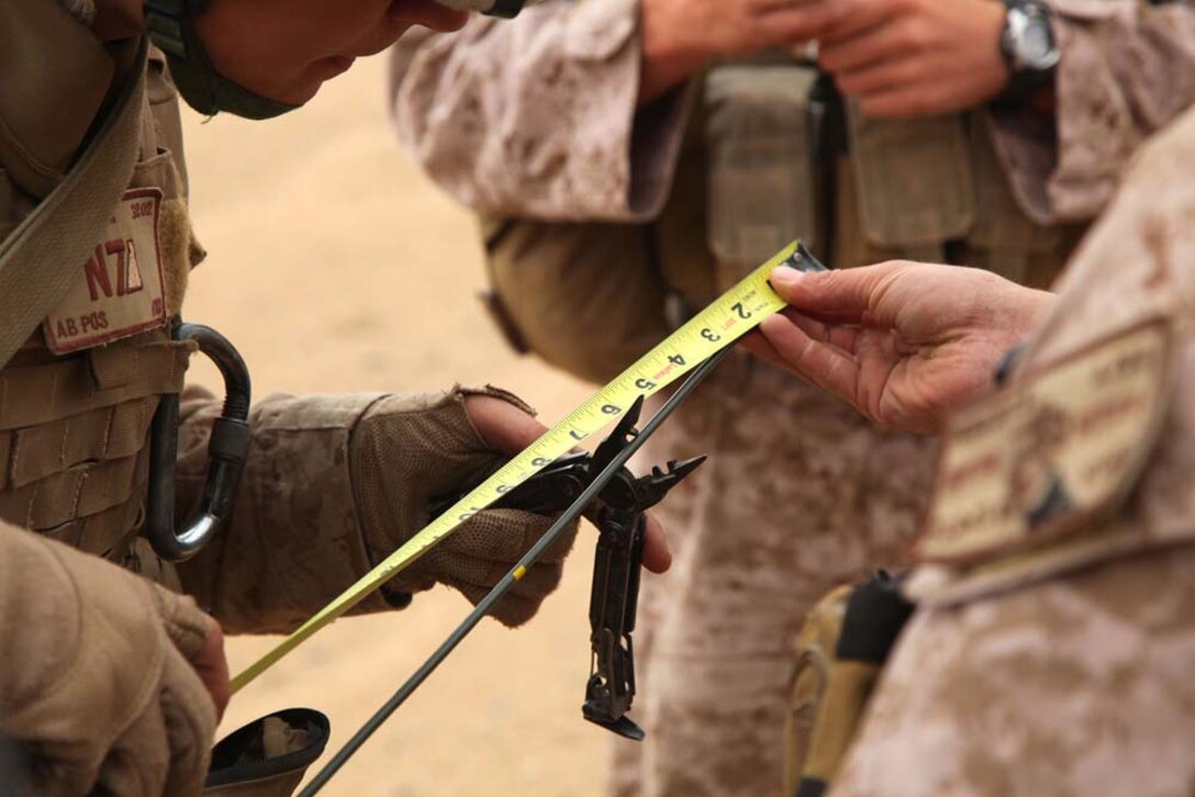 Marines assigned to Engineer Detachment, Combat Logistics Battalion 15, 15th Marine Expeditionary Unit, measure and cut a fuse to use for a controlled detonation at a live-fire range near Camp Buehring, Kuwait, during a routine training exercise, Nov. 25. With the use of shape and cratering charges and composition C-4, the combat engineers were able to use the high explosives to demonstrate practical applications they could use in a combat environment.The 15th MEU is deployed as part of the Peleliu Amphibious Ready Group as a U.S. Central Command theater reserve force, providing support for maritime security operations and theater security cooperation efforts in the U.S. 5th Fleet area of responsibility. (U.S. Marine Corps photo by Cpl. Timothy R. Childers/Unreleased)