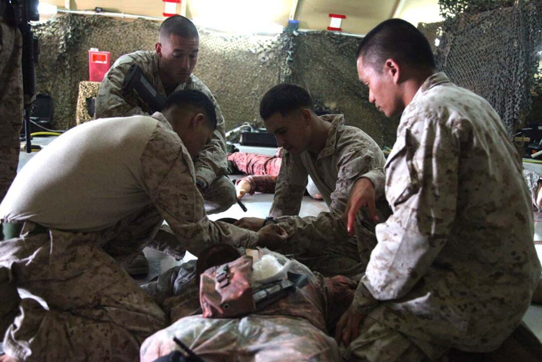 U.S. Marines assigned  to Combat Logistics Battalion 15, 15th Marine Expeditionary Unit, practice combat life-saving skills on a dummy during a CLS class at Camp Buehring, Kuwait, during Exercise Eager Mace 13, Nov. 21. The U.S. Navy and Marine Corps are participating in the bilateral training exercise with the Kuwait Armed Forces to expand levels of cooperation, enhance mutual maritime capabilities and promote long-term regional stability and interoperability between U.S. forces and regional partners. The 15th MEU is deployed as part of the Peleliu Amphibious Ready Group as a U.S. Central Command theater reserve force, providing support for maritime security operations and theater security cooperation efforts in the U.S. 5th Fleet area of responsibility. (U.S. Marine Corps photo by Cpl. Timothy R. Childers/Released)