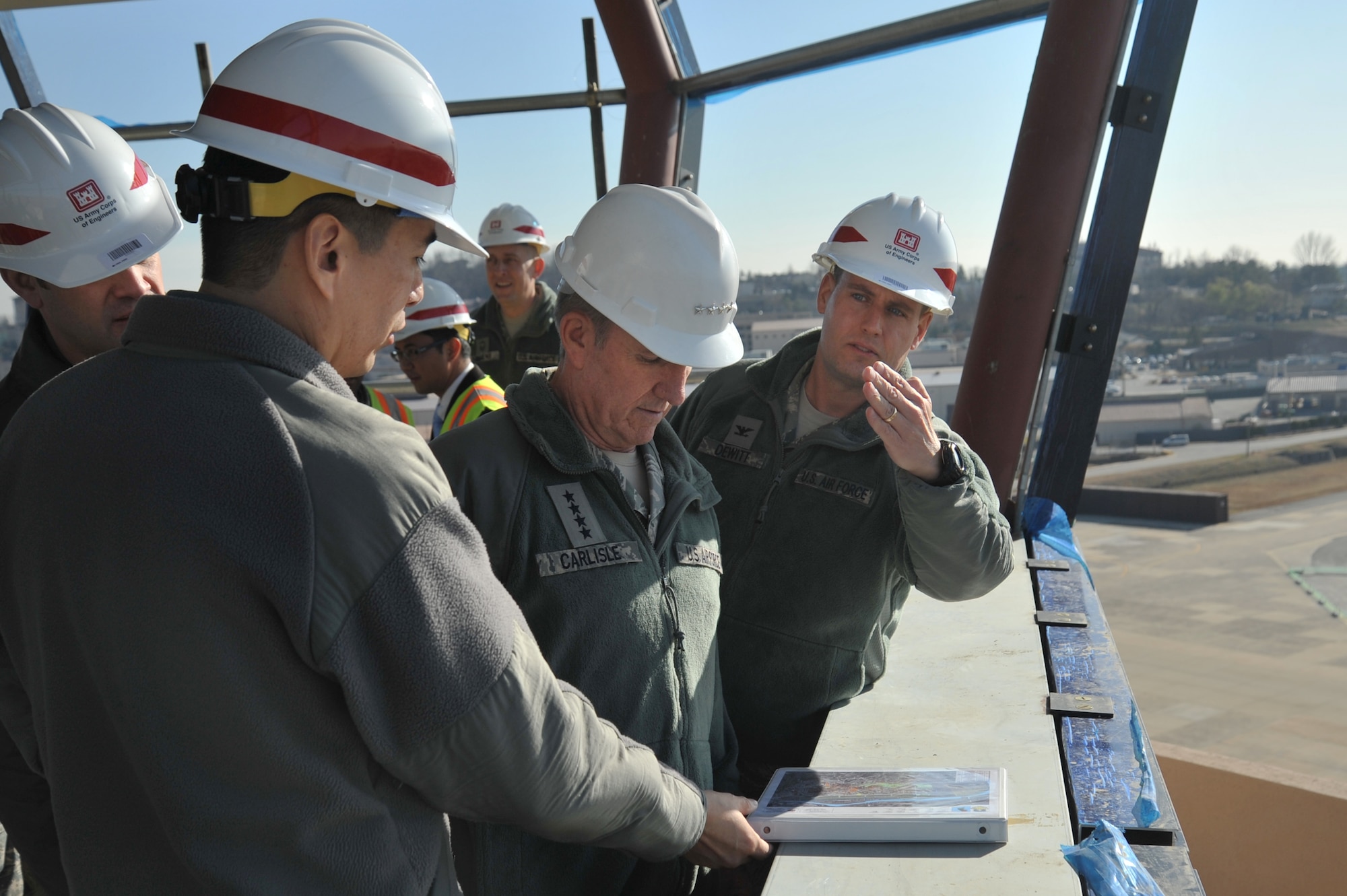 Col. Sean DeWitt (right), 51st Fighter Wing vice commander, and Lt. Col. Roland Secody (left), 51st Civil Engineer Squadron commander, explain the purpose of a newly constructed tower project to Gen. Herbert J. Carlisle, Pacific Air Forces commander, during his visit to Osan Air Base, Republic of Korea, Nov. 29, 2012. The project is still in the construction stage with an estimated completion date of March 2013. (U.S. Air Force photo/Staff Sgt. Craig Cisek)