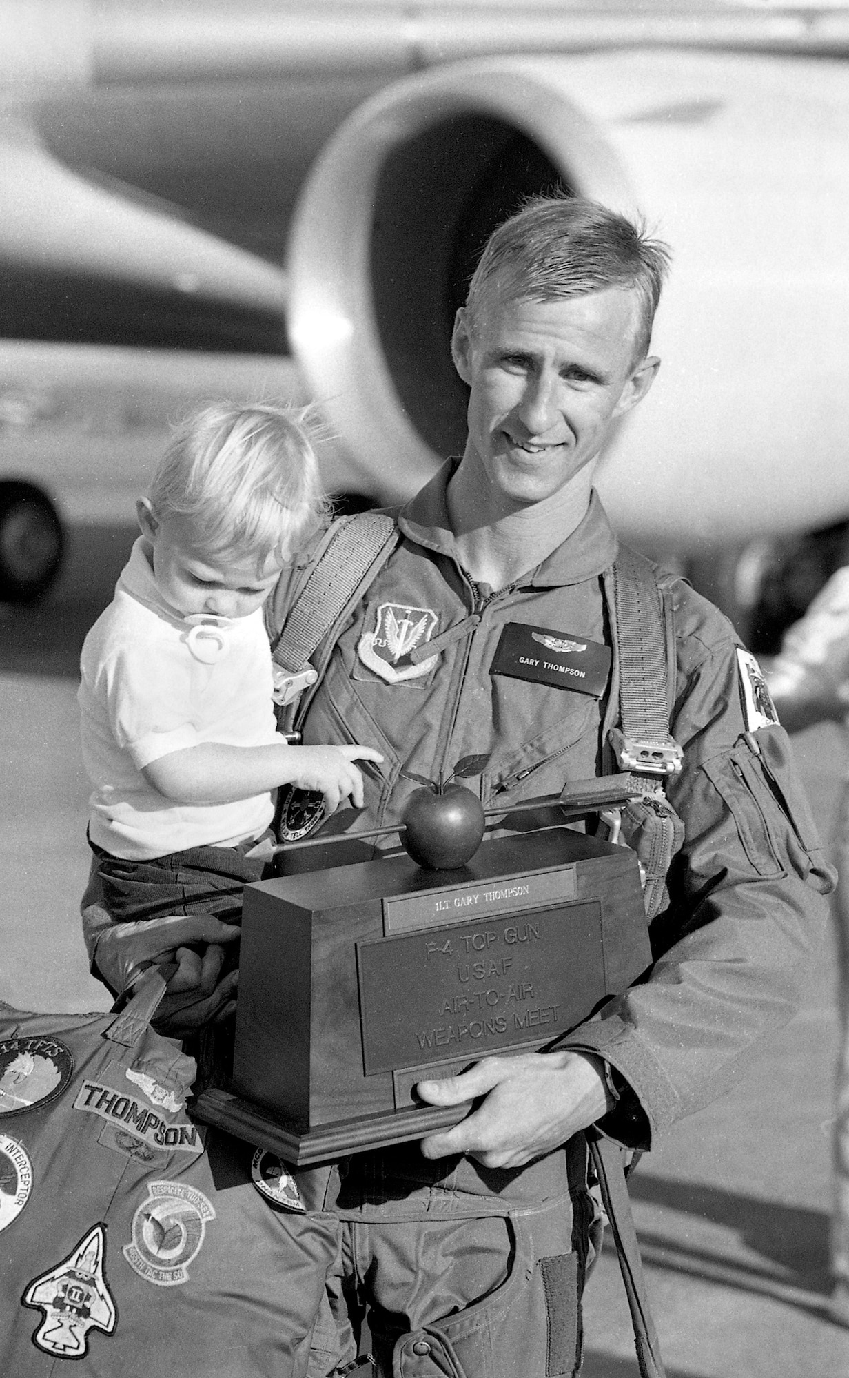 Oregon Air National 1st Lt. Gary Thompson with his son Jason pose for a photograph at the Portland Air National Guard Base, Portland, Ore., in August of 1988, after he has returned from the 1988 William Tell Weapons Meet at Tyndall AFB, Fla. after winning the Top Shooter award.  (photo courtesy of the 142nd Fighter Wing Public Affairs Department)