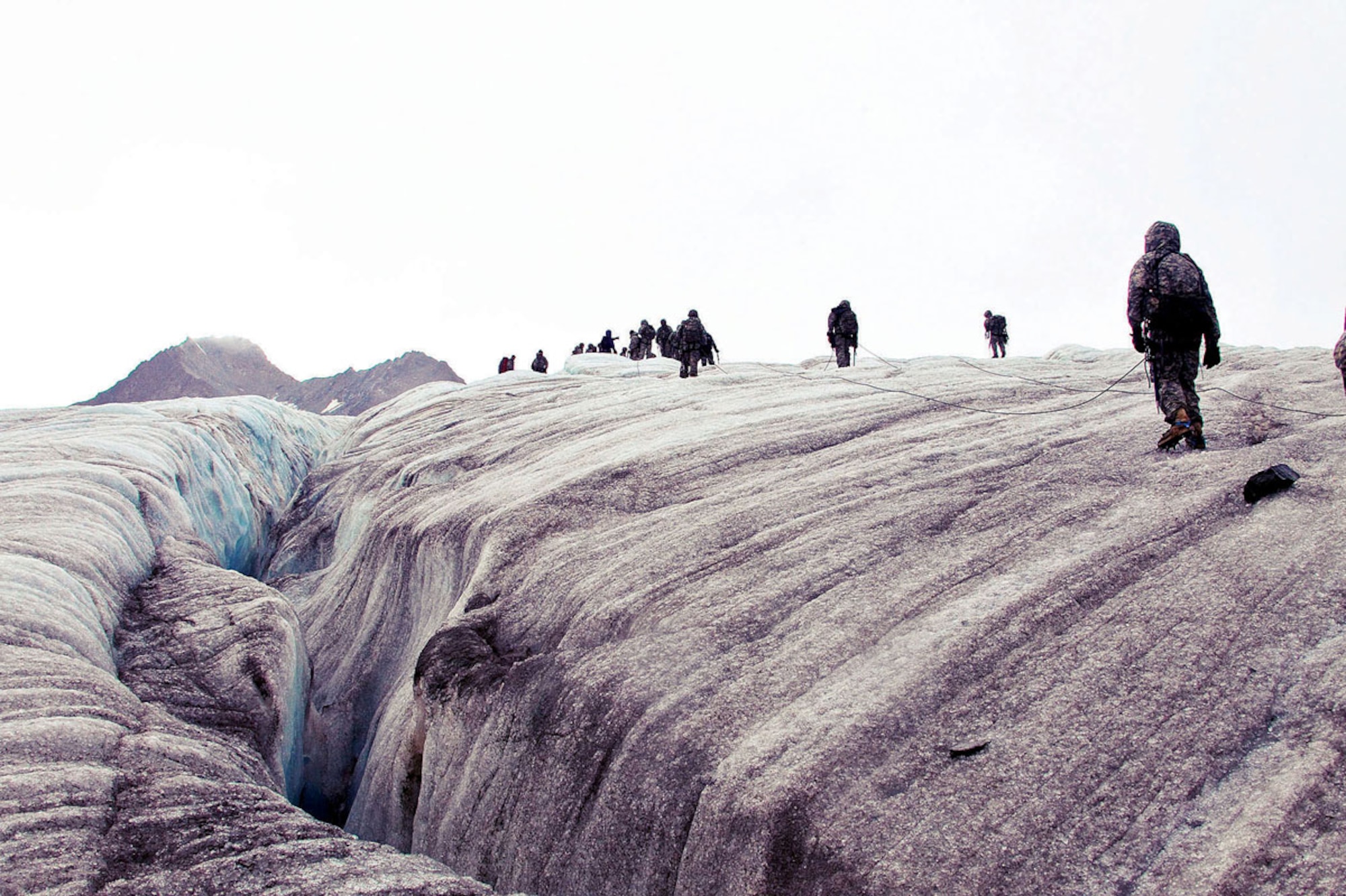 Basic Mountaineering Class students stay roped together as they traverse across the Gulkanna Glacier, deep in Alaska’s back country.  The BMC teaches crevasse rescues techniques, team work, safety and cold-weather survival.  (U.S. Army Photo/Staff Sgt. Brehl Garza)