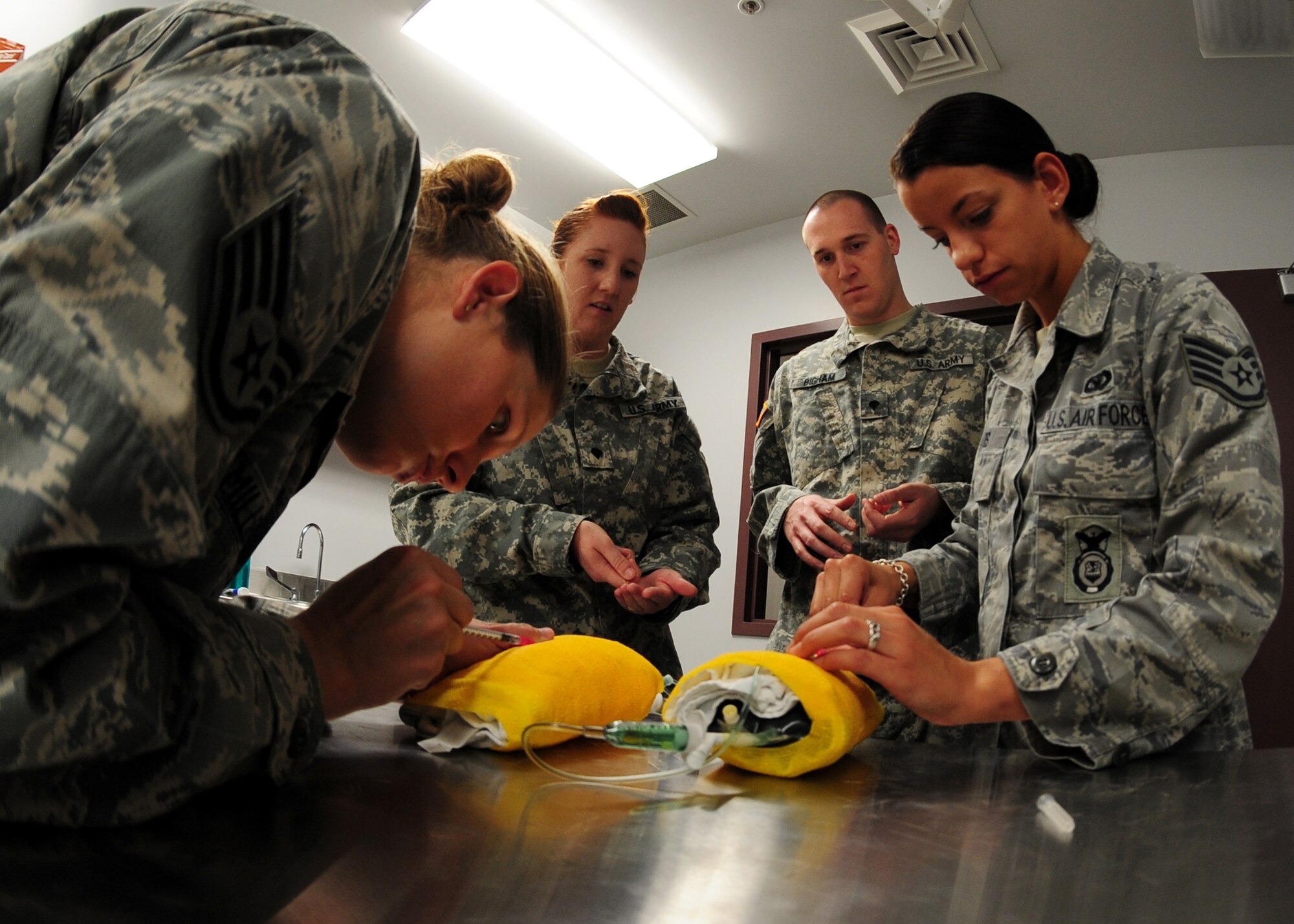 Military working dog handlers from the 9th Security Forces Squadron train using props at the Beale Air Force Base, Calif., kennels, Nov. 29, 2012. Handlers learn skills used to stabilize animals in the event of a life threatening injury. (U.S. Air Force photo by Senior Airman Shawn Nickel/Released)