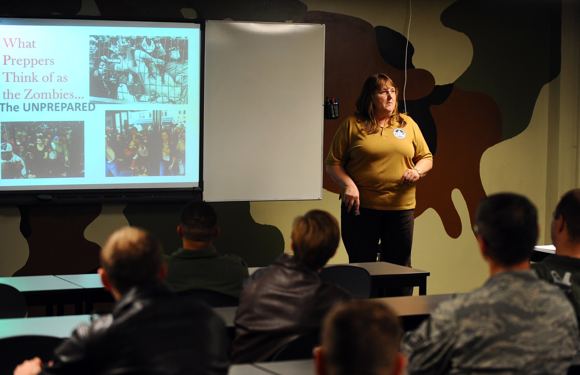 Rhonda Woolridge, 55th Wing Civil Engineer Squadron emergency management flight, provides a Doomsday Prepper presentation, informing Airmen on some simple precautionary measures they could adopt to better prepare for an emergency situation, inside of Building C, on Offutt Air Force Base, Neb., Nov. 26.  The men and women of the Fightin’ Fifty-Fifth were able to participate in briefings ranging from leadership to disaster preparedness as part of Wingman Day.  (U.S. Air Force photo by Josh Plueger/Released)