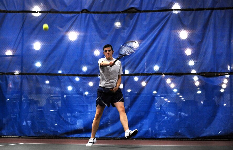 U.S. Air Force Airman 1st Class Richard Schott, 55th Maintenance Squadron, plays tennis with coworker U.S. Air Force Airman 1st Class Naeem Sanders while enjoying the day-long Wingman Day at the field house on Offutt Air Force base, Neb., Nov. 26.  Wingman Day is an annual event where Airman come together to participate in an array of activities promoting team work.  (U.S. Air Force photo by Josh Plueger/Released)