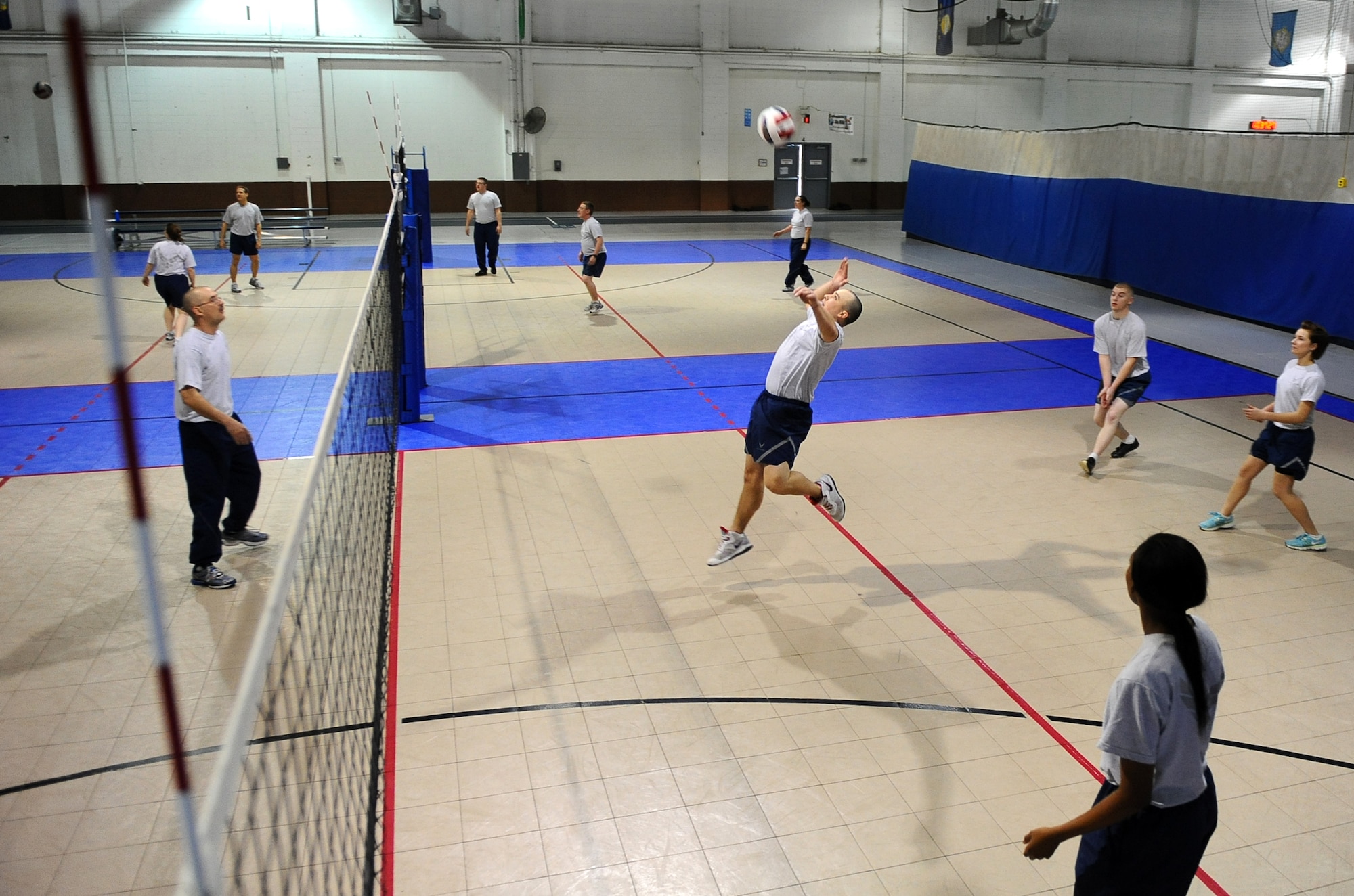U.S. Air Force Staff Sgt. Robert Chitwood, 55th Maintenance Squadron, returns a serve while competing in Wingman Day’s volleyball game held at the field house on Offutt Air Force Base, Neb., Nov. 26.  Both sporting events and a variety of briefings made up the day-long event where Airmen got the chance to have some fun and also learn skills to better their Air Force lives.  (U.S. Air Force photo by Josh Plueger/Released)