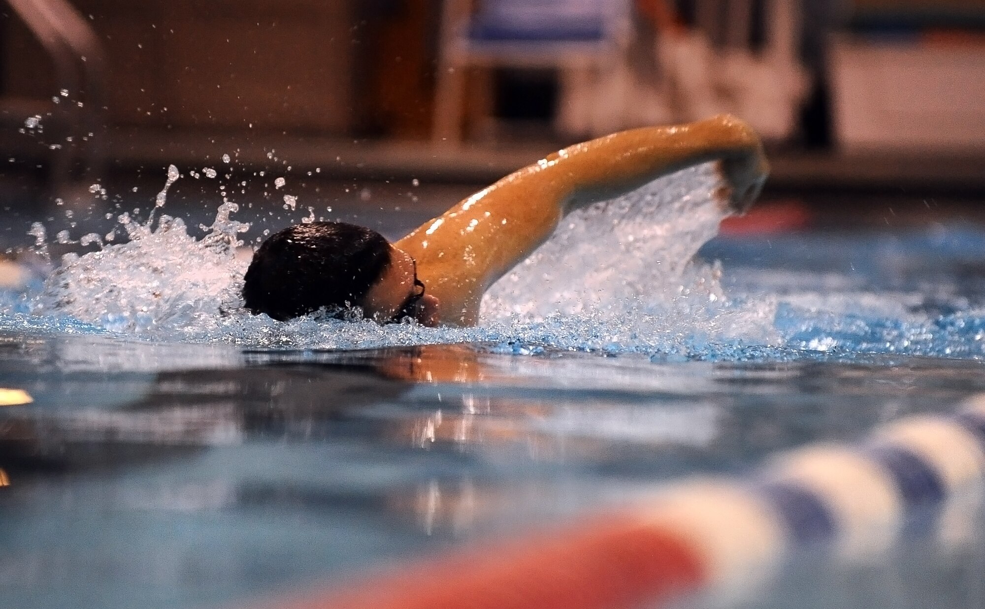 U.S. Air Force 2nd Lt. Quinn Lowry swims against U.S. Air Force Tech. Sgt. Chad Stoulil, both of the the 55th Logistics Readiness Squadron, during Wingman Day held at the field house on Offutt Air Force Base, Neb., Nov. 26.  Sports and team building exercises were held at numerous locations throughout the base with an emphasis on Comprehensive Airman Fitness.  (U.S. Air Force photo by Josh Plueger/Released)