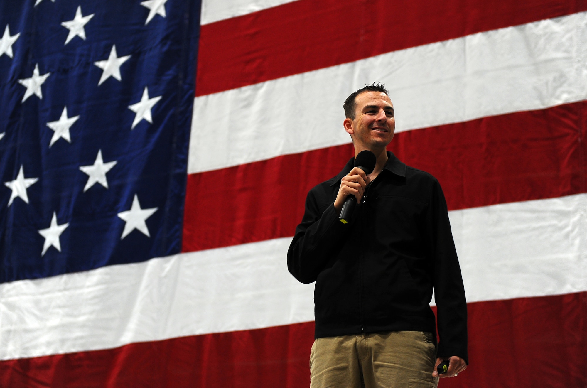 Wingman Day’s guest speaker Brian Flemming, former U.S. Army infantryman injured in Afghanistan, speaks to hundreds of Offutt Airmen inside of Bennie Davis Maintenance Facility Dock 1 at Offutt Air Force Base Neb., Nov. 26.  Flemming spoke about the four pillars of Comprehensive Airman Fitness and their importance on maintaining a healthy home life as well as a productive asset to the armed forces.  (U.S. Air Force photo by Josh Plueger/Released)