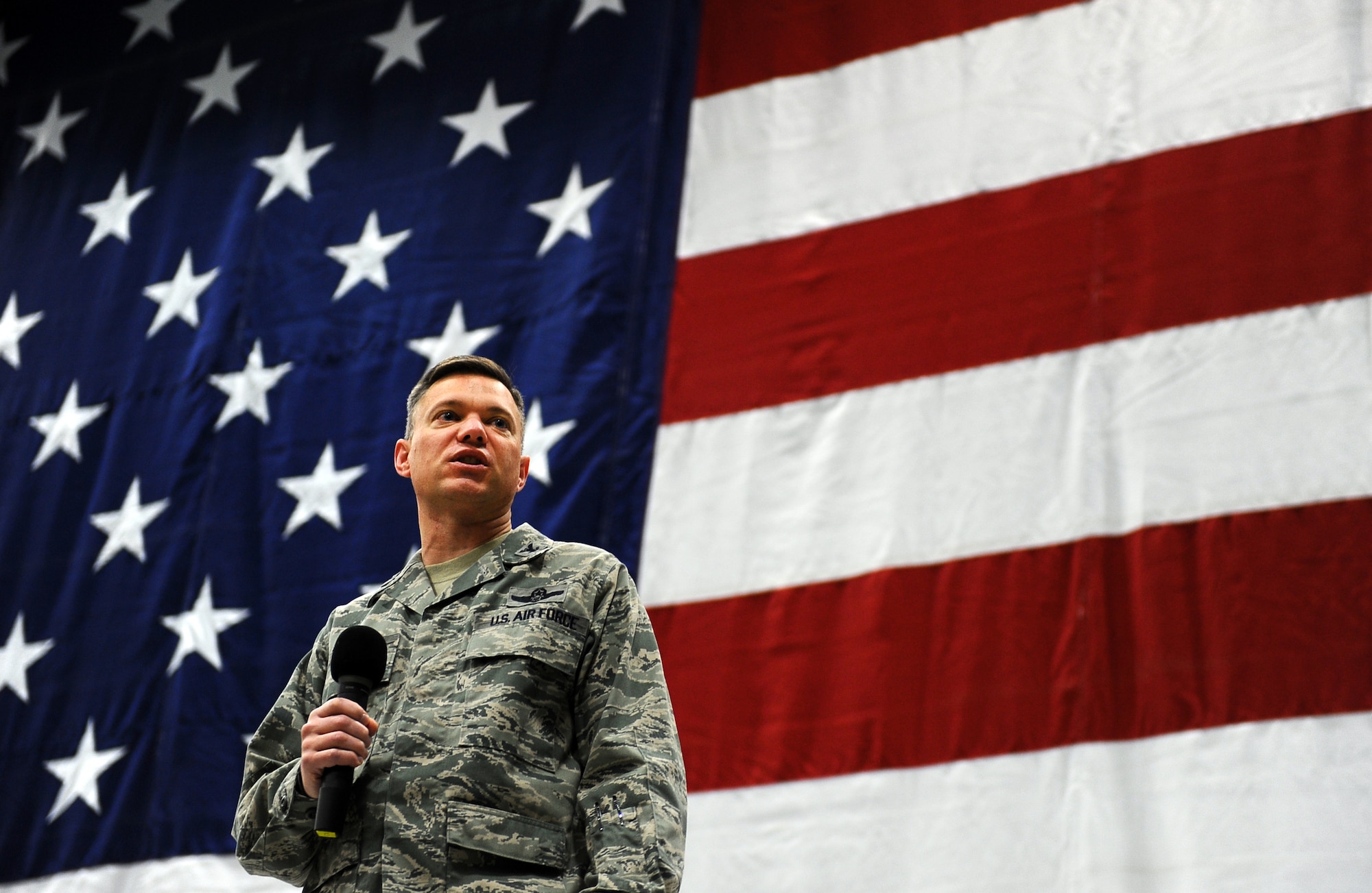 U.S. Air Force Col. John Rauch, 55th Wing commander, provides Wingman Day opening remarks to the men and women of the Fightin’ Fifty-Fifth inside of Dock 1 of the Bennie Davis Maintenance Facility on Offutt Air Force Base, Neb., Nov. 26.  The annual Wingman Day hosts several team building exercises throughout the base and includes everything from team sports to leadership briefings.  (U.S. Air Force photo by Josh Plueger/Released)