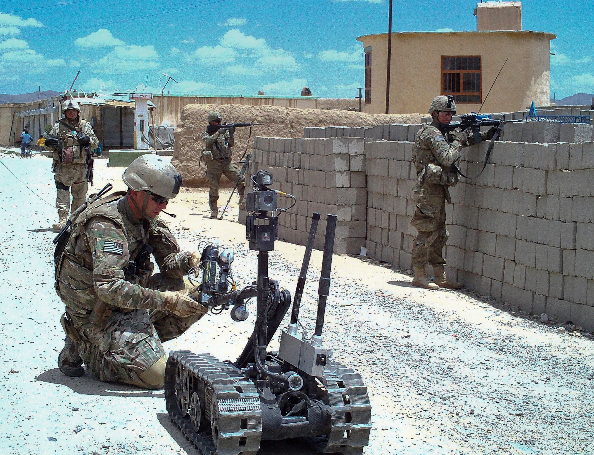 Tech Sgt. Peter Arbelo, 87th Civil Engineer Squadron Explosive Ordnance Disposal operations and training noncommissioned officer, deployed with the 966th EOD flight, places a C-4 charge in a Talon robot’s grippers June 26, 2012, in the Ghanzi Province, Afghanistan. The charge was intended for a 140 pound improvised explosive device down the road. (U.S. Air Force courtesy photo/Released)