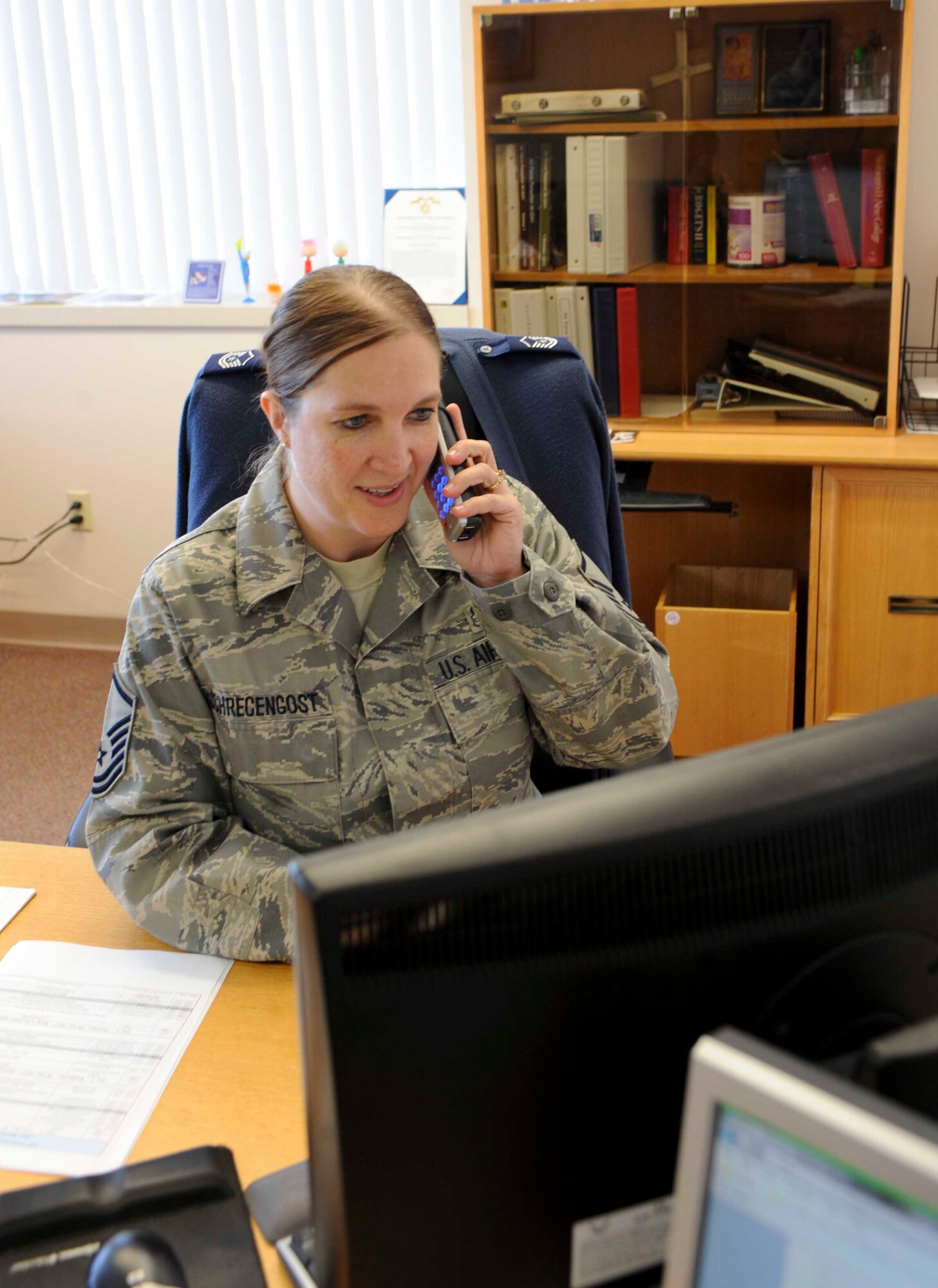 Master Sgt. Nancy Schrecengost, 28th Force Support Squadron career assistance advisor, assists a customer from her office inside the Rushmore Center at Ellsworth Air Force Base, S.D., Nov. 27, 2012. Airmen looking to change career fields while continuing to serve within the Air Force are able to contact MSgt. Schrecengost at her office at (605) 385-2367. (U.S. Air Force photo by Airman 1st Class Anania Tekurio/Released)