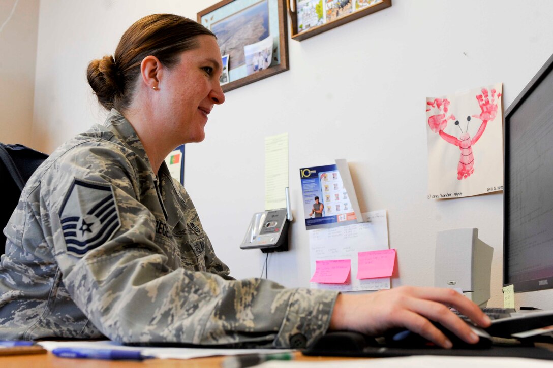 Master Sgt. Nancy Schrecengost, 28th Force Support Squadron career assistance advisor, retrieves air force specialty codes at her desk inside the Rushmore Center at Ellsworth Air Force Base, S.D., Nov. 27, 2012. As a career assistance advisor, MSgt. Schrecengost is able to provide information and opportunities to Airmen interested in cross-training into a new career field within the Air Force. (U.S. Air Force photo by Airman 1st Class Anania Tekurio/Released)