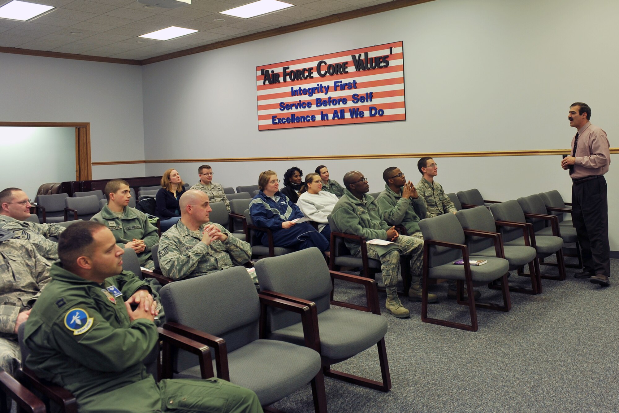 Kenneth Komyathy, with the 55th Force Support Squadron, speaks to the crowd about resolving love issues with their spouses during Wingman Day in 55th Operations Support Squadron auditorium on Offutt Air Force Base, Neb., Nov. 26.  Team Offutt members took part in various events and briefings during the day to promote teamwork and educate Airmen on topics such as suicide prevention and the dangers of drinking and driving. (U.S Air Force photo by Charles Haymond/Released)