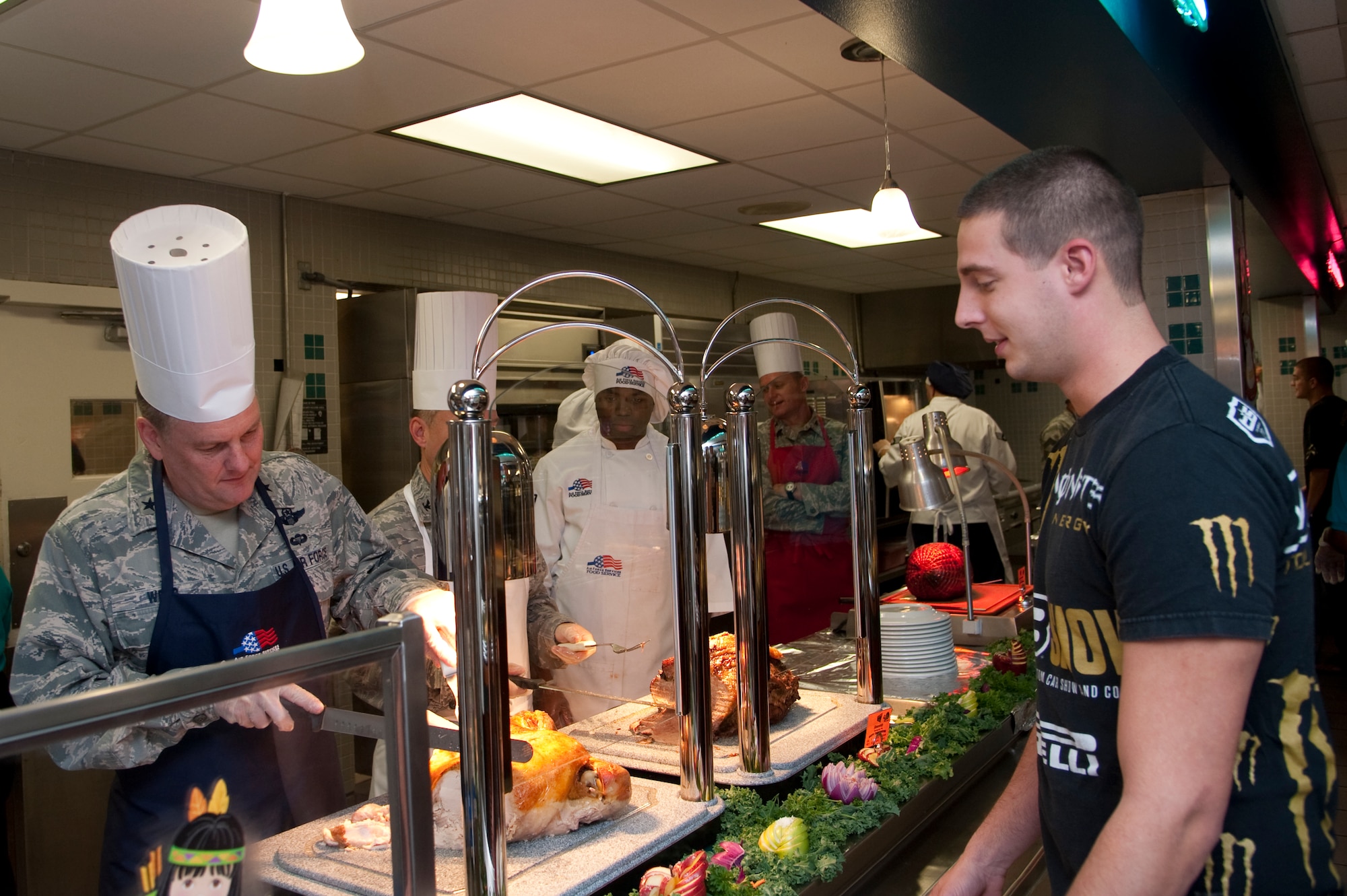 U.S. Air Force Brig. Gen. Marshall Webb, director of plans, programs, requirements and assessments of Air Force Special Operations Command, carves a slice of turkey for Airman 1st Class Zachary Barkley, mission systems apprentice of 1st Special Operations Component Maintenance Squadron, at The Reef dining facility at Hurlburt Field, Fla., Nov. 22, 2012. Distinguished guests from the base served Airmen a special Thanksgiving lunch.(U.S. Air Force photo/ Airman 1st Class Nigel Sandridge)