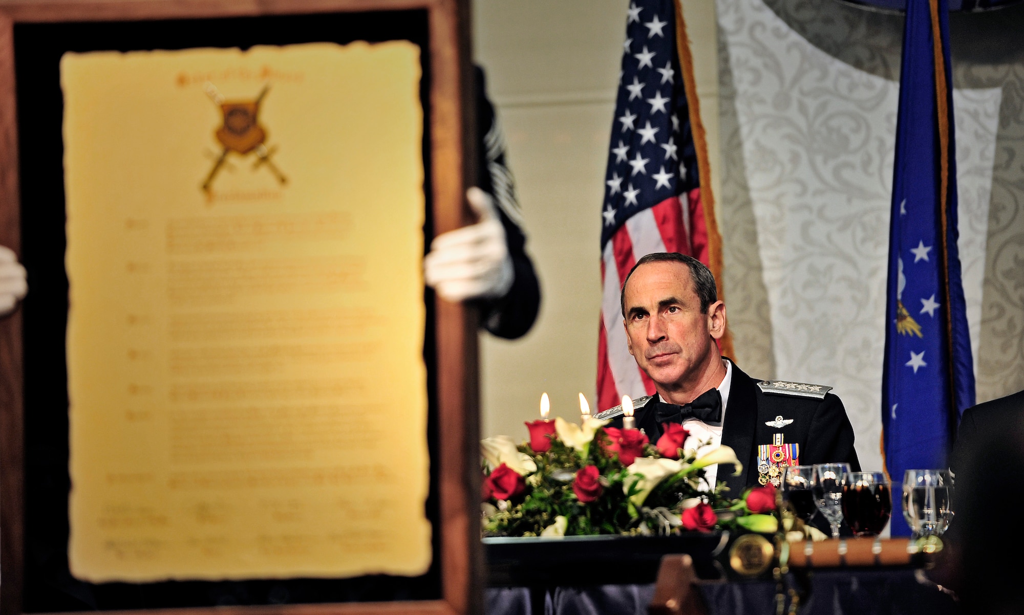Gen. Raymond E. Johns Jr., Air Mobility Command commander, listends to a proclamation during his Order of the Sword ceremony at the Scott Air Force Base Club, Nov. 28, 2012. The Order of the Sword is a special program where noncommisioned officers of a command recognize individuals who have made significant contributions to the enlisted corps. Johns is the 10th AMC commander to be awared this honor. (U.S. Air Force photo/ Staff Sgt. Ryan Crane)