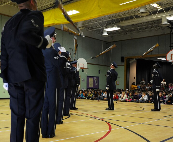 Members of the U.S. Air Force Honor Guard Drill Team toss their M-1 rifles during a performance at Belvedere Elementary School in Falls Church, Va., Nov. 26, 2012.   Inspiring patriotism and garnering interest in the U.S. Air Force are key aspects of the Drill Team mission.  (U.S. Air Force photo/Staff Sgt. Torey Griffith)