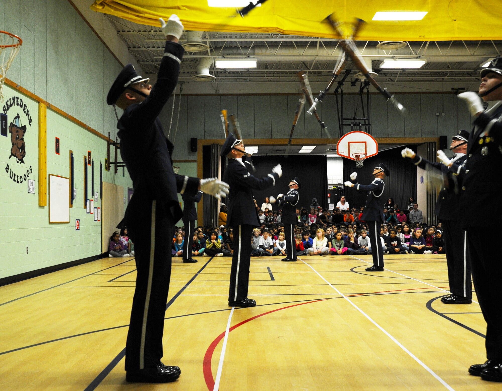 Members of the U.S. Air Force Honor Guard Drill Team toss their M-1 rifles during a performance at Belvedere Elementary School in Falls Church, Va., Nov. 26, 2012.   Inspiring patriotism and garnering interest in the U.S. Air Force are key aspects of the Drill Team mission.  (U.S. Air Force photo/Staff Sgt. Torey Griffith)