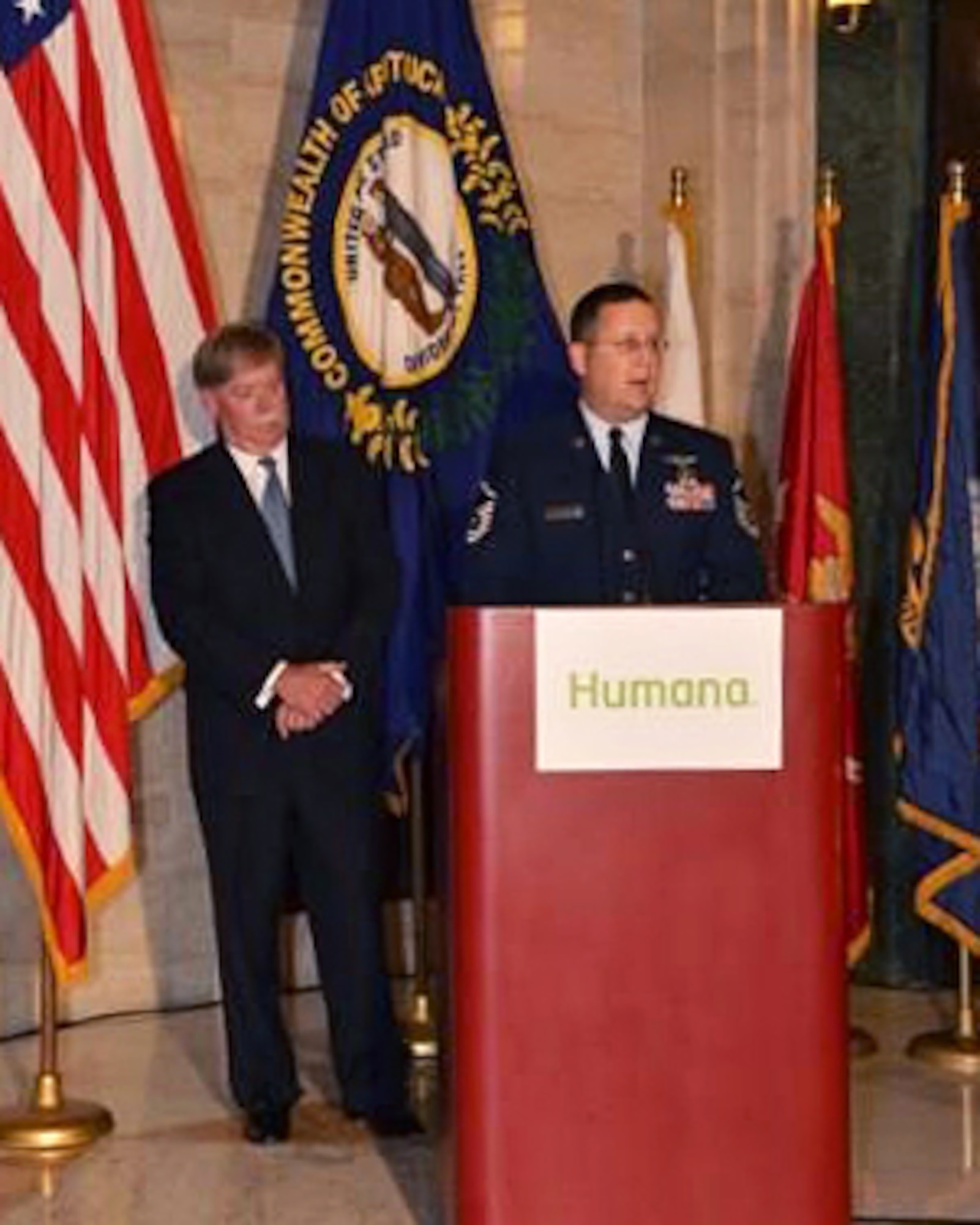 Master Sgt. James Tongate, a Humana employee and loadmaster with the Kentucky Air National Guard's 165th Airlift Squadron, speaks during a ceremony at Humana's corporate headquarters in Louisville, Ky. Humana was being honored as a finalist for the Secretary of Defense Employer Support Freedom Award, the highest recognition given by the U.S. government to employers for exceptional support of employees serving in the Guard and Reserve. Also pictured is Mike McCallister, Humana's chief executive officer. (Courtesy photo)