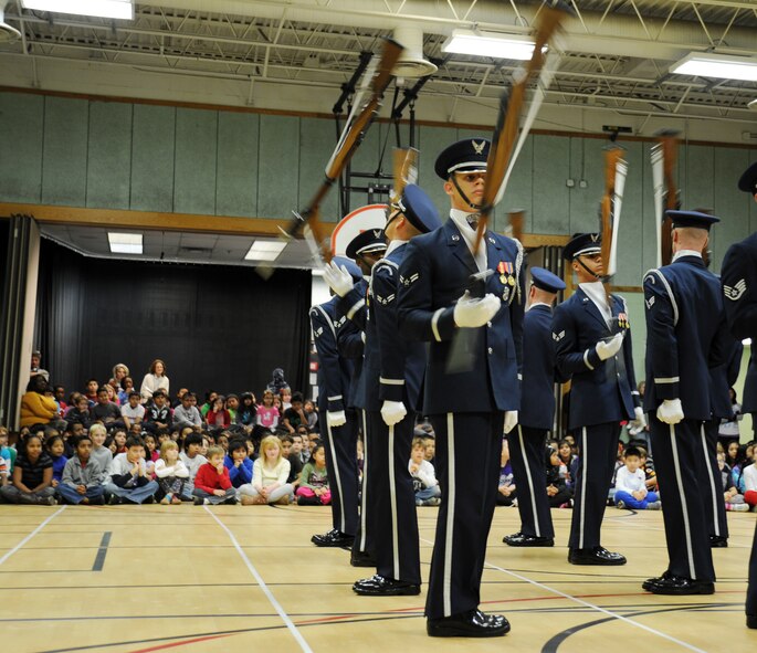 Members of the U.S. Air Force Honor Guard Drill Team toss their M-1 rifles during a performance at Belvedere Elementary School in Falls Church, Va., Nov. 26, 2012.   Inspiring patriotism and garnering interest in the U.S. Air Force are key aspects of the Drill Team mission.  (U.S. Air Force photo/Staff Sgt. Torey Griffith)