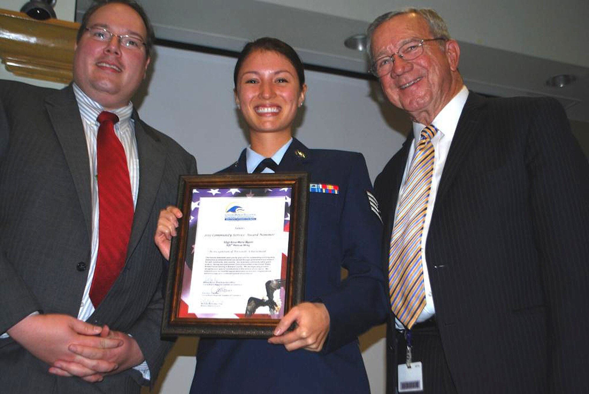 Staff Sgt. Anna-Marie Wyant, 920th Rescue Wing public affairs, accepts her nomination for a Military Affairs Counsel Community Service Award Wednesday at an awards banquet. Tech. Sgt. Charity Orris, 308th Rescue Squadron, was also nominated but unable to attend. (U.S. Air Force photo/Chris Calkins)