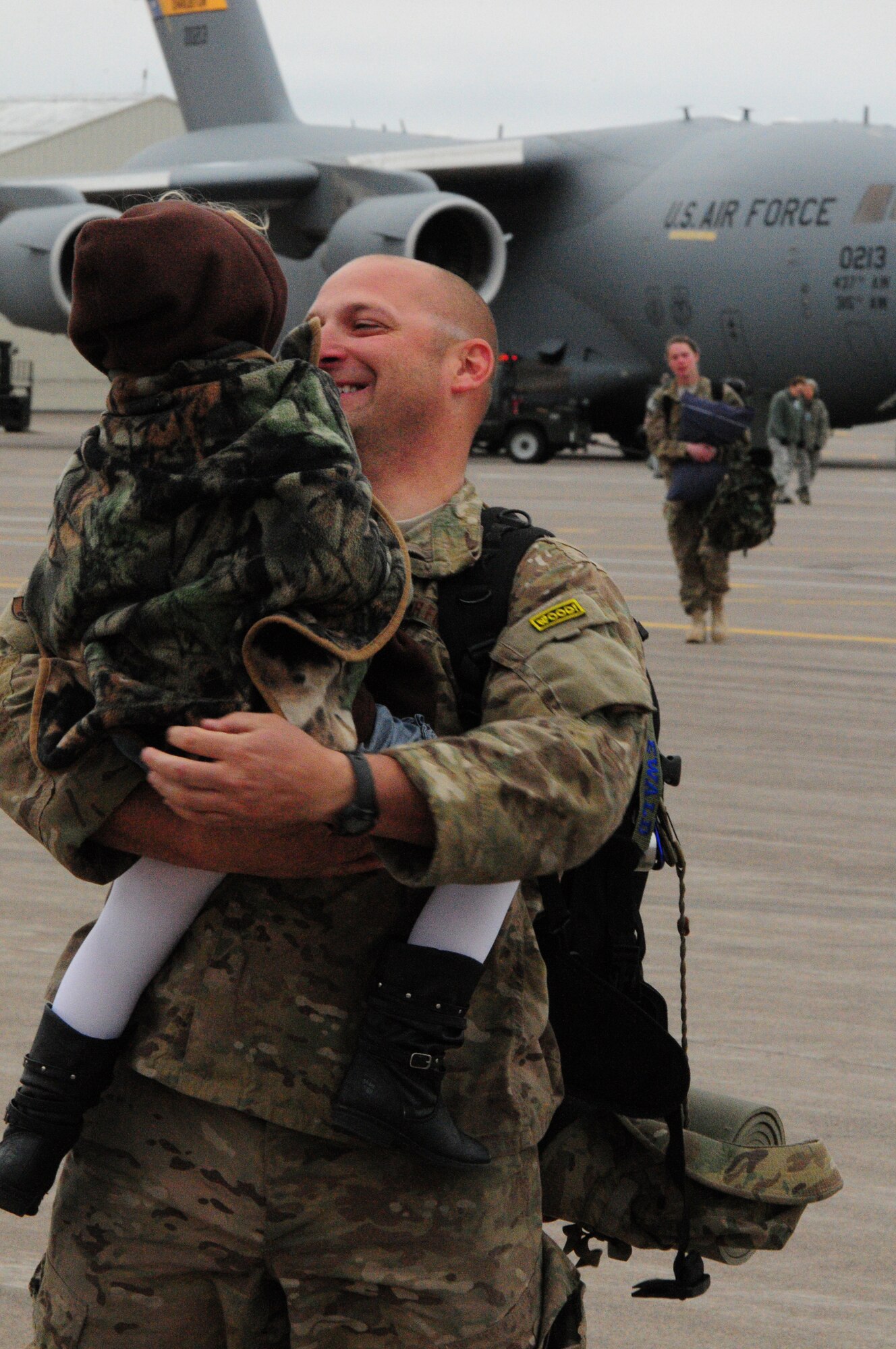 A 148th Fighter Wing member is greeted by his daughter after returning from Kandahar Airfield, Afghanistan, Oct. 22, 2012.  The 148th Fighter Wing, Minnesota Air National Guard, deployed approximately 300 airmen to Afghanistan in August, 2012 in support of Operation Enduring Freedom.  (National Guard photo by Tech. Sgt. Brett R. Ewald/ Released)