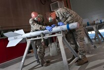 Staff Sgt. Daniel Manzer, left, and Tech. Sgt. Jonathan Kidd work on an AIM-9 Sidewinder missile during exercise Green Flag-West 13-02 at Nellis Air Force Base, Nev., Nov. 2, 2012. Kidd is assigned to the 187th Fighter Wing, Alabama Air National Guard, and Manzer is with the 57th Maintenance Squadron at Nellis AFB. (U.S. Air Force photo/Val Gempis)