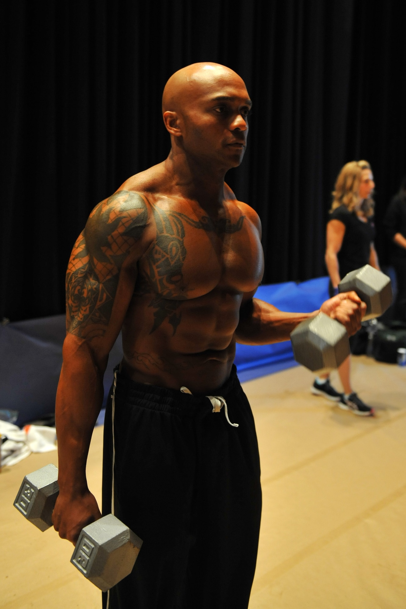 Master Sgt. LaJuan Fuller, 366th Civil Engineer Squadron first sergeant, lifts some small weights to warm up his muscles before his body building competition April 28, 2012, in Boise, Idaho. Fuller has participated in more than 18 competitions. (U.S. Air Force photo/Airman 1st Class Heather Hayward)
