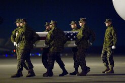 A U.S. Marine Corps carry team transfers the remains of Cpl. Christopher M. Monahan Jr. of Island Heights, N.J., at Dover Air Force Base, Del., Nov. 28, 2012. Monahan was assigned to Combat Logistics Battalion 2, Combat Logistics Regiment 2, 2nd Marine Logistics Group, II Marine Expeditionary Force, Camp Lejeune, N.C. (U.S. Air Force photo/Greg L. Davis)
