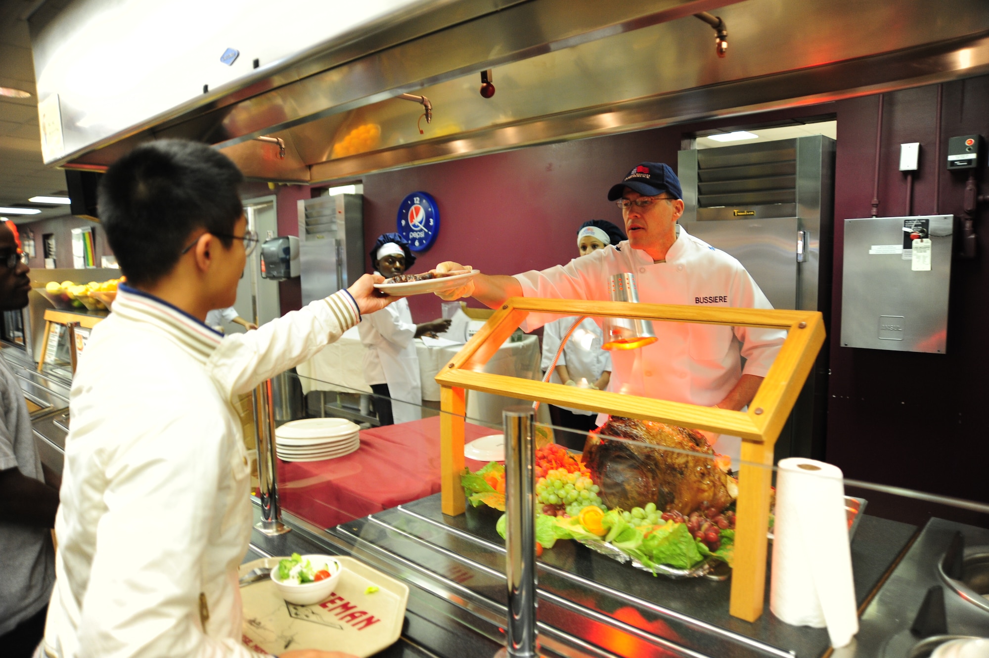 Brig. Gen. Thomas Bussiere, 509th Bomb Wing Commander, serves a thanksgiving meal to Airman 1st Class Joe Ly, 509th Maintenance Squadron low observable apprentice, Nov. 22 at Whiteman Air Force Base, Mo. General Bussiere and other members of wing leadership served food to Airmen and their families during an annual Thanksgiving Day celebration. (U.S. Air Force photo/Senior Airman Nick Wilson) (Released)