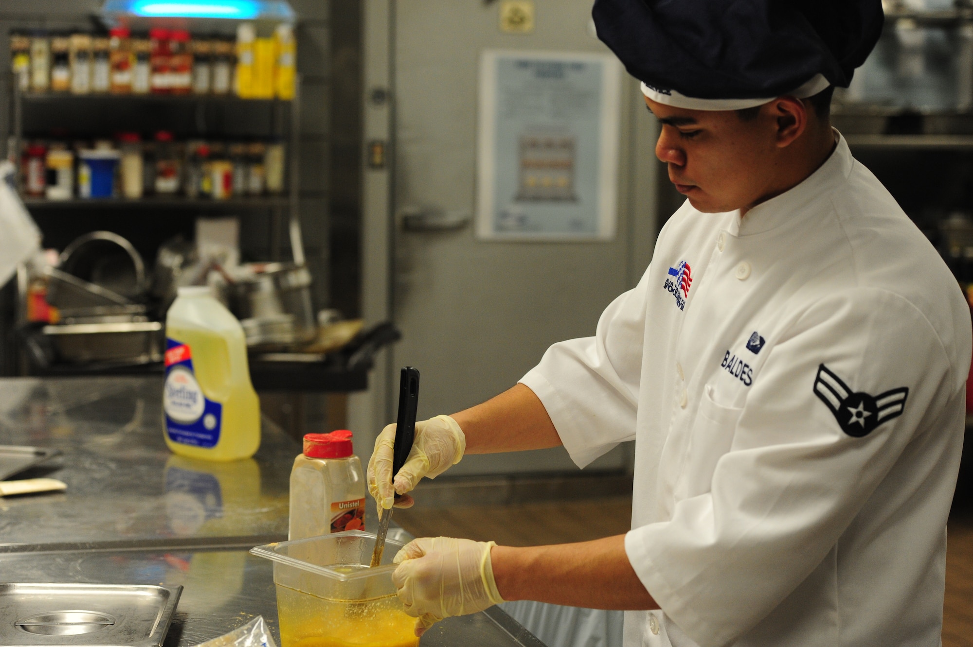 Airman 1st Class Francisco Balderas Garcia, 509th Force Support Squadron, prepares an item for the Thanksgiving Day meal Nov. 22 at Whiteman Air Force Base, Mo. Each year, the Ozark Inn Dining Facility hosts a Thanksgiving Day meal for Airmen and their families. The event helps boosts morale for Airmen working through the holidays and can’t make it home to their families. (U.S. Air Force photo/Senior Airman Nick Wilson) (Released)