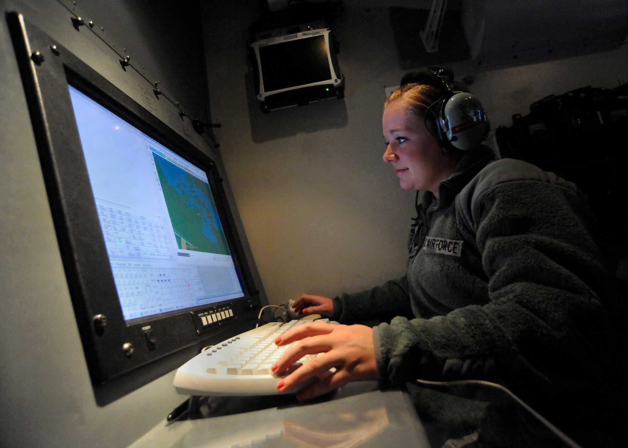 Oregon Air National Guard Senior Airman Brittani Schammen, a 116th surveillance technician, Camp Rilea Ore., is scanning the display screen so she can identify simulated aircraft flying in and around the active air space during a joint training exercise, Sept. 26, 2012.