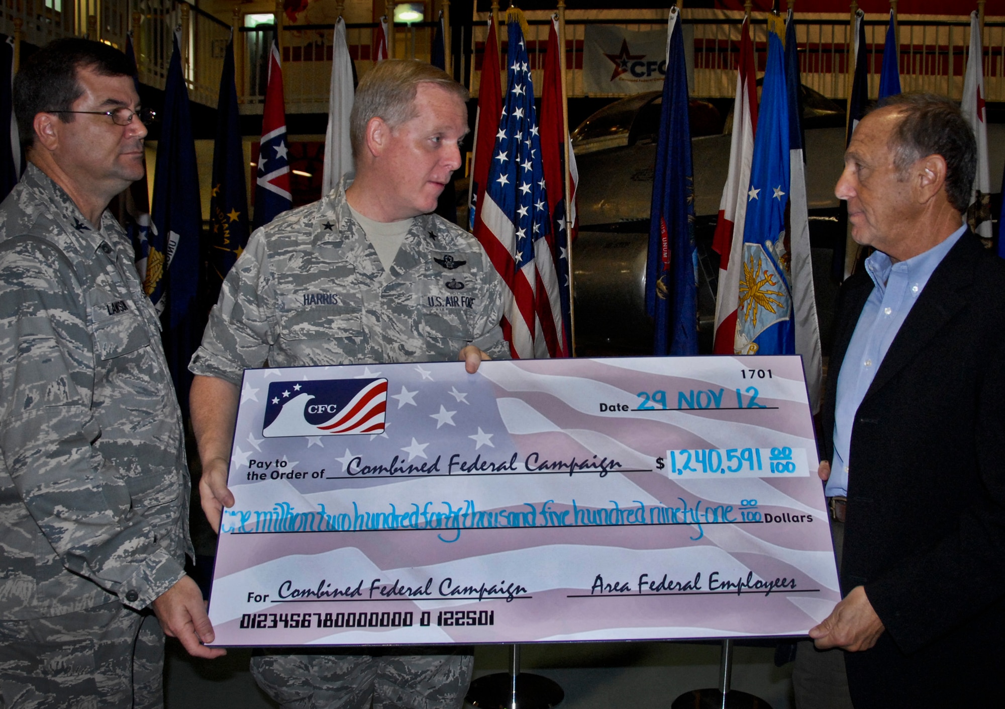 Brig. Gen. David Harris, the 96th Test Wing commander and Col. Randy Lawson, the 1st Special Operations Group commander at Hurlburt Field, present a check for $1,240,591 to Jack Azzaretto, the United Way chairman of the board for Okaloosa and Walton counties, at the Combined Federal Campaign victory celebration at the Air Force Air Armament Museum Nov. 29.  The check represented funds gathered at Eglin Air Force Base, Hurlburt Field and area federal agencies during this year’s CFC drive.  (U.S. Air Force photo/Kevin Gaddie)