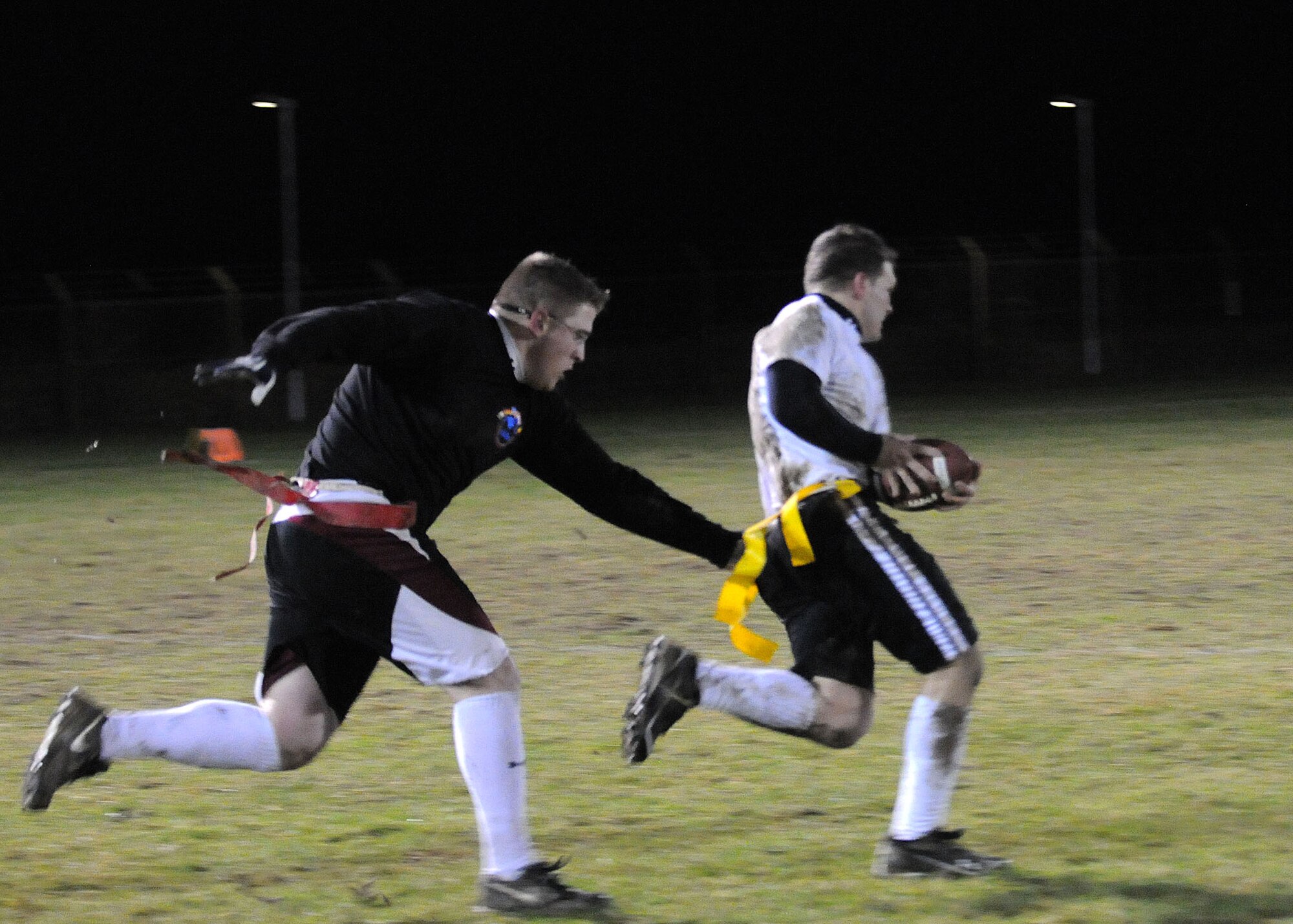 Tech. Sgt. Christopher Klare, 488th Intelligence Squadron watch supervisor, removes the flag from Senior Airman Jeremie Anderson, 67th Special Operations Squadron loadmaster, during a flag football game Nov. 28, 2012, at RAF Mildenhall, England. The game was the part of the flag football play-offs on base. (U.S. Air Force photo by Airman 1st Class Kelsey A.L. Waters/Released)
